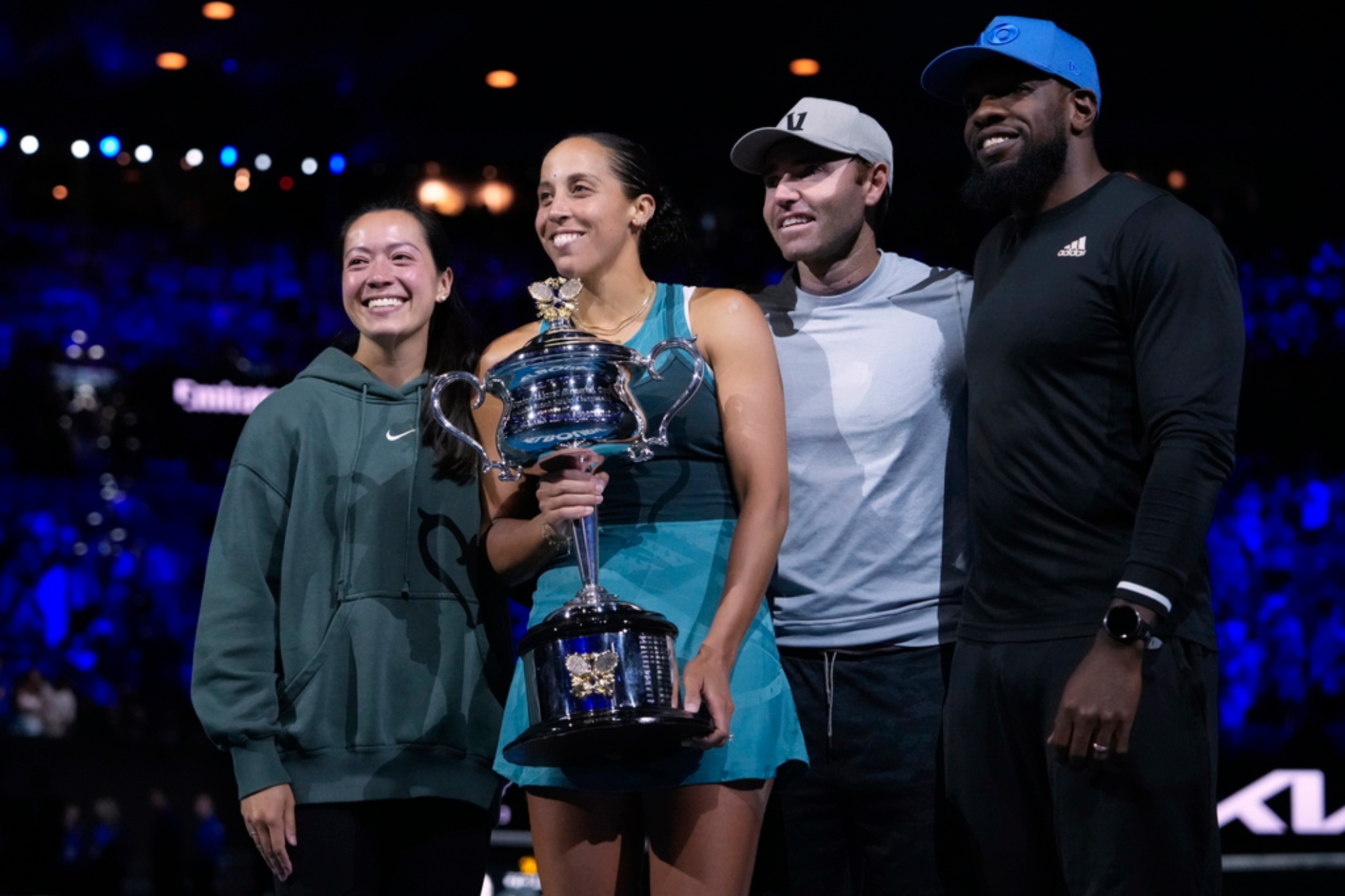 Keys holds the Daphne Akhurst Memorial Cup with her coaching team after defeating Sabalenka in the womens singles final.