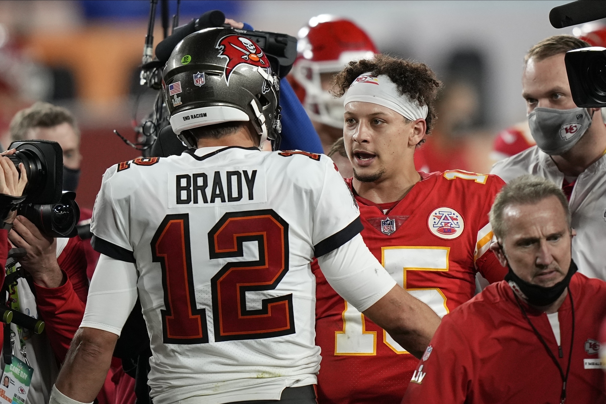 Tampa Bay Buccaneers quarterback Tom Brady, speaks with Kansas City Chiefs quarterback Patrick Mahomes after Super Bowl 55