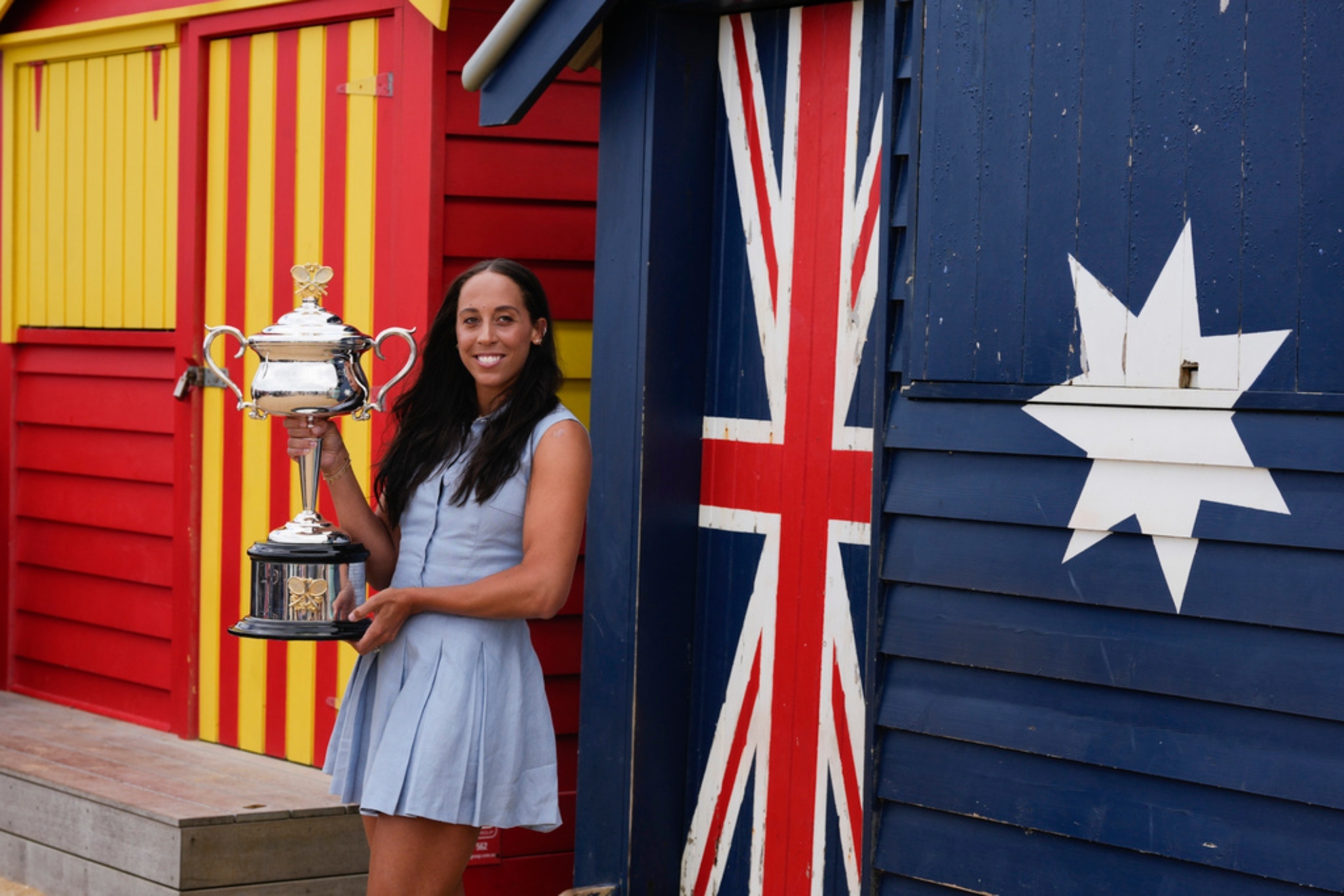Madison Keys holds the Daphne Akhurst Memorial Cup at the Brighton Beach Boxes the morning after defeating Sabalenka.