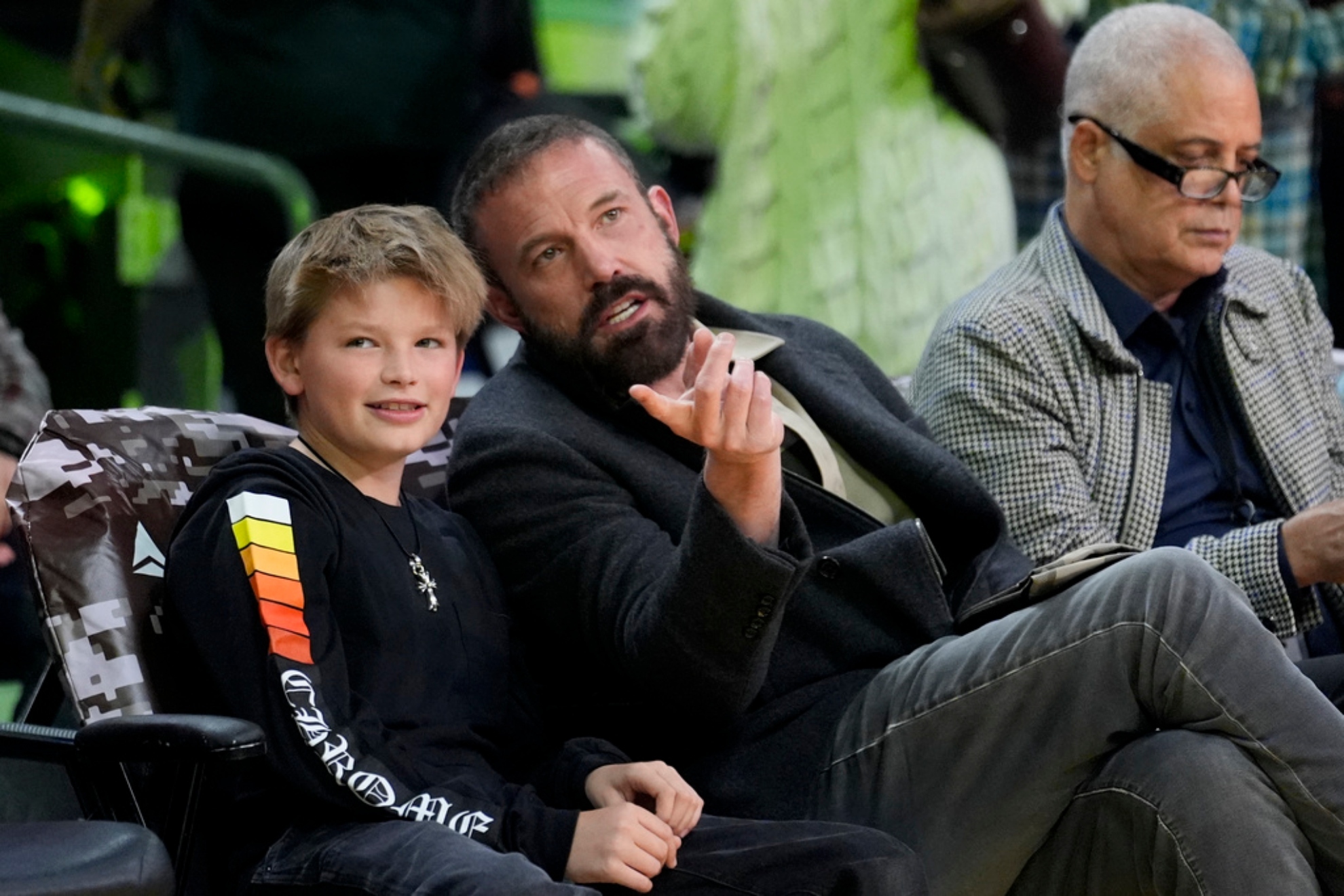 Actor Ben Affleck talks to his son Samuel before an NBA basketball game.