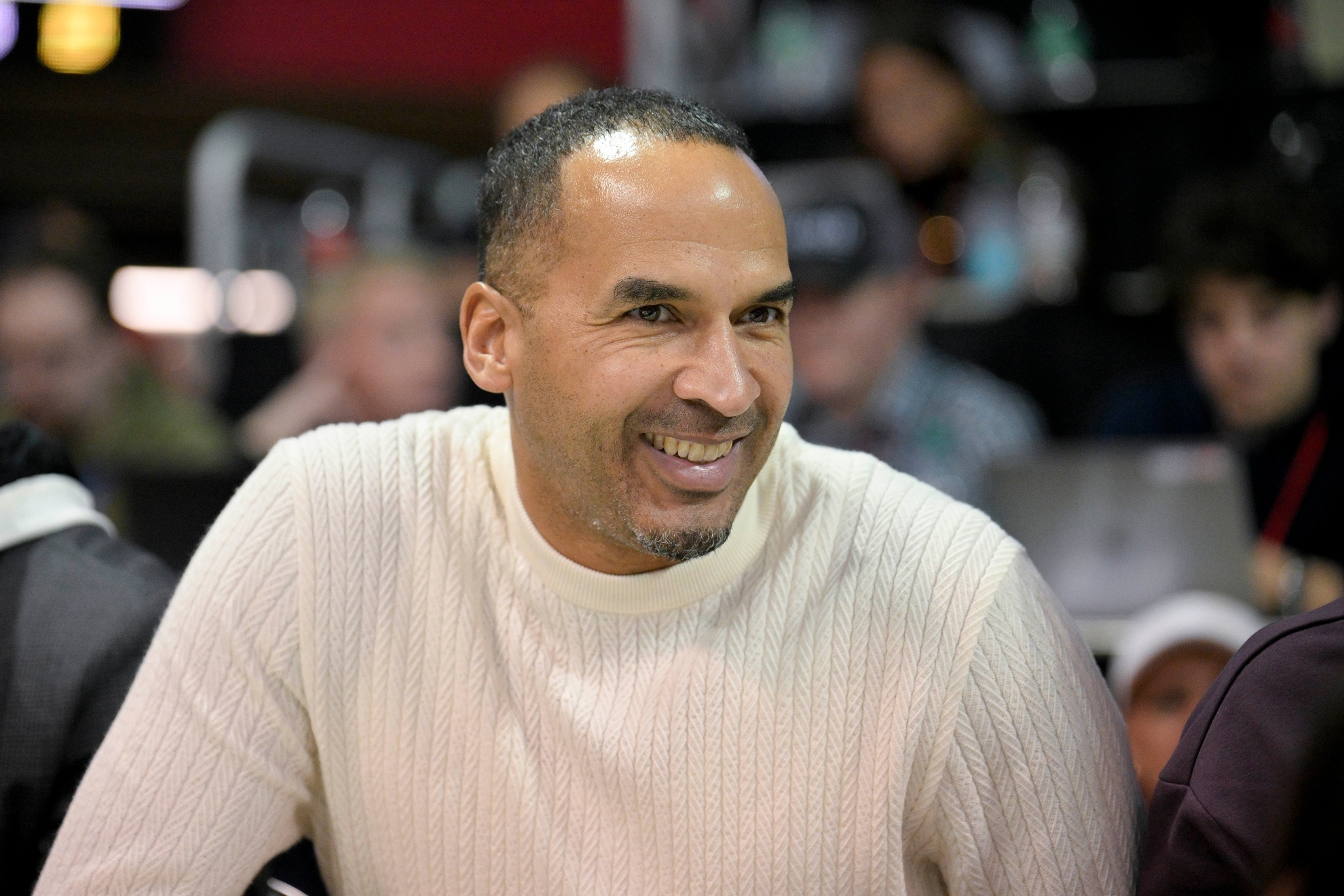 Dallas Mavericks general manager Nico Harrison watches an NCAA college basketball game.