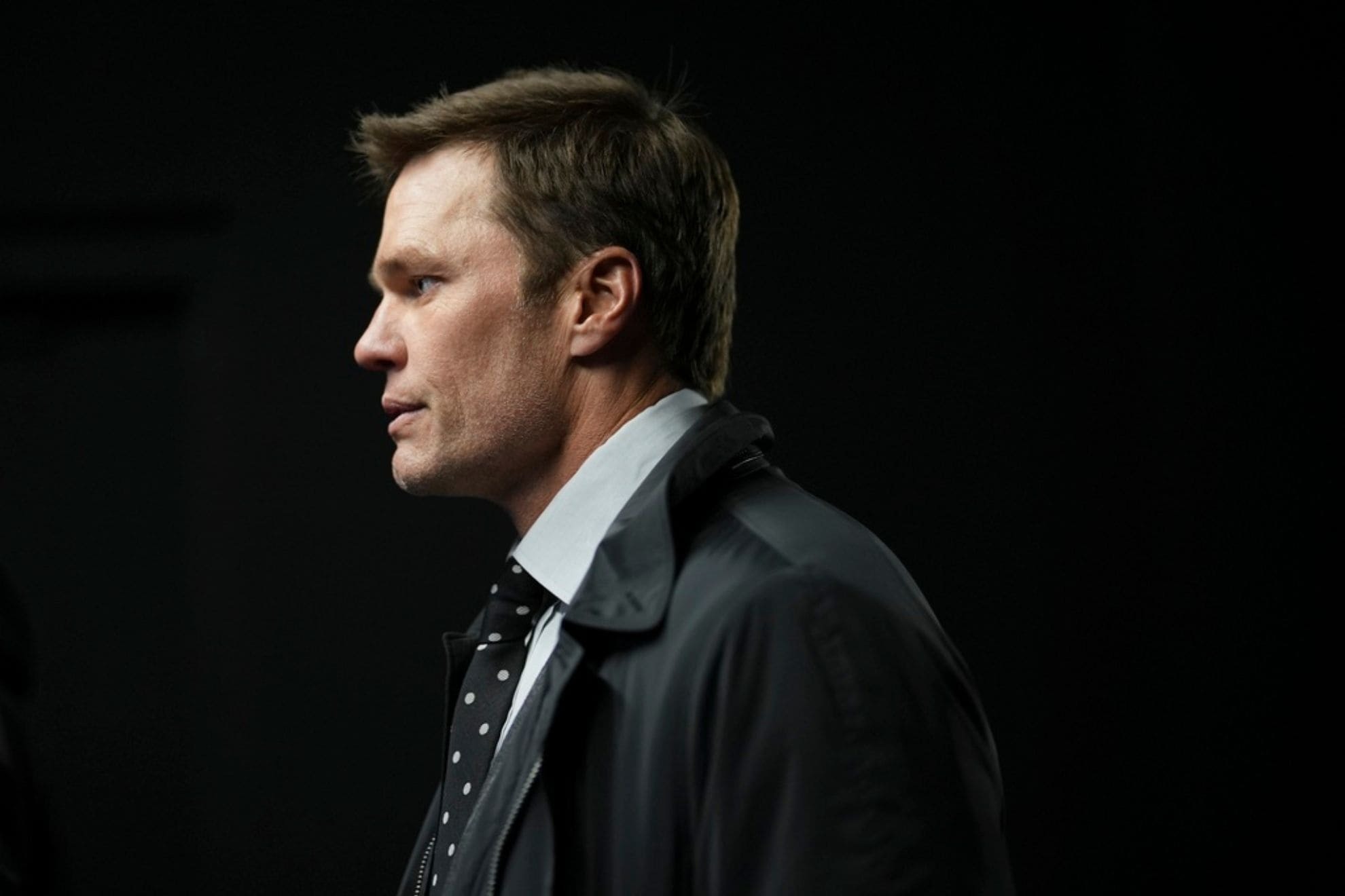 Former quarterback Tom Brady walks in a tunnel before an NFL football game between the Philadelphia Eagles and the Pittsburgh Steelers on Sunday, Dec. 15, 2024, in Philadelphia. (AP Photo/Matt Slocum)
