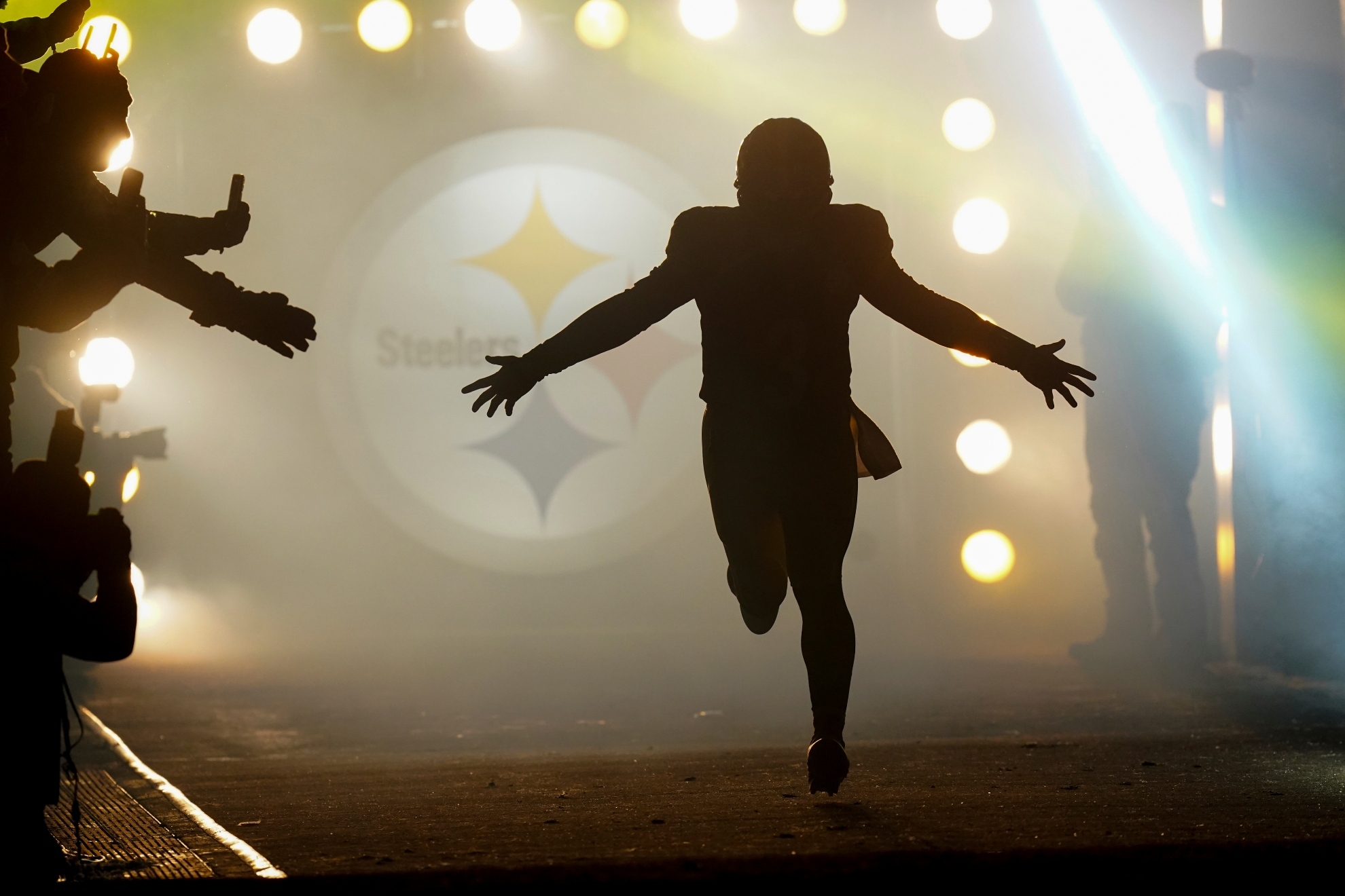 Pittsburgh Steelers quarterback Russell Wilson runs onto the field as he is introduced before an NFL football game against the Cincinnati Bengals in Pittsburgh, Saturday, Jan. 4, 2025.