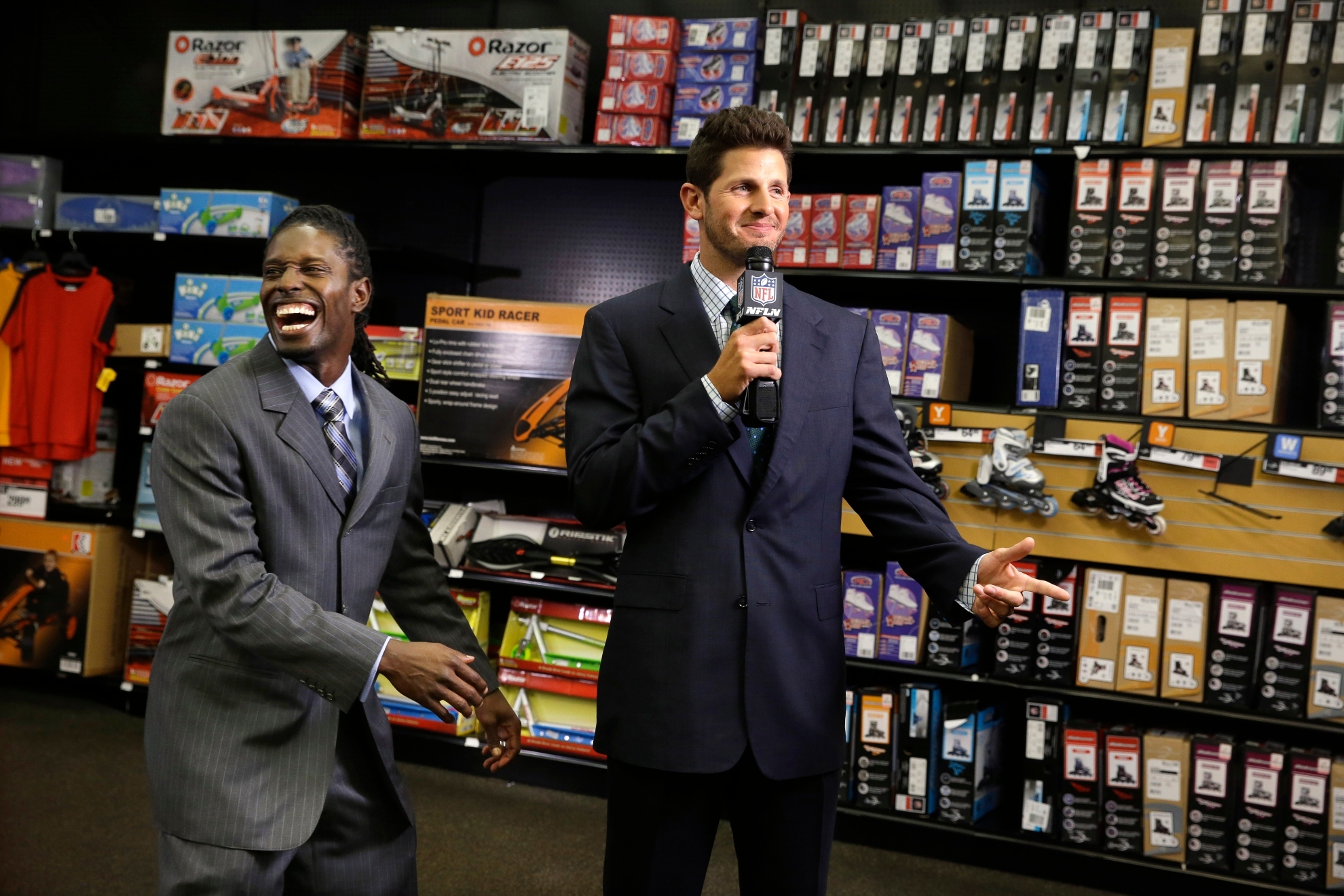In this photo taken on Wednesday, June 18, 2014, NFL Super Bowl MVP, wide receiver Deion Branch, left, reacts as quarterback Dan Orlovsky cant recall a line as they work on interviews at a sporting goods store during the NFLs Broadcast Boot Camp in Mount Laurel, N.J. Twenty-five current and former players participating in the NFLs Broadcast Boot Camp this week, are vying for broadcasting gigs.
