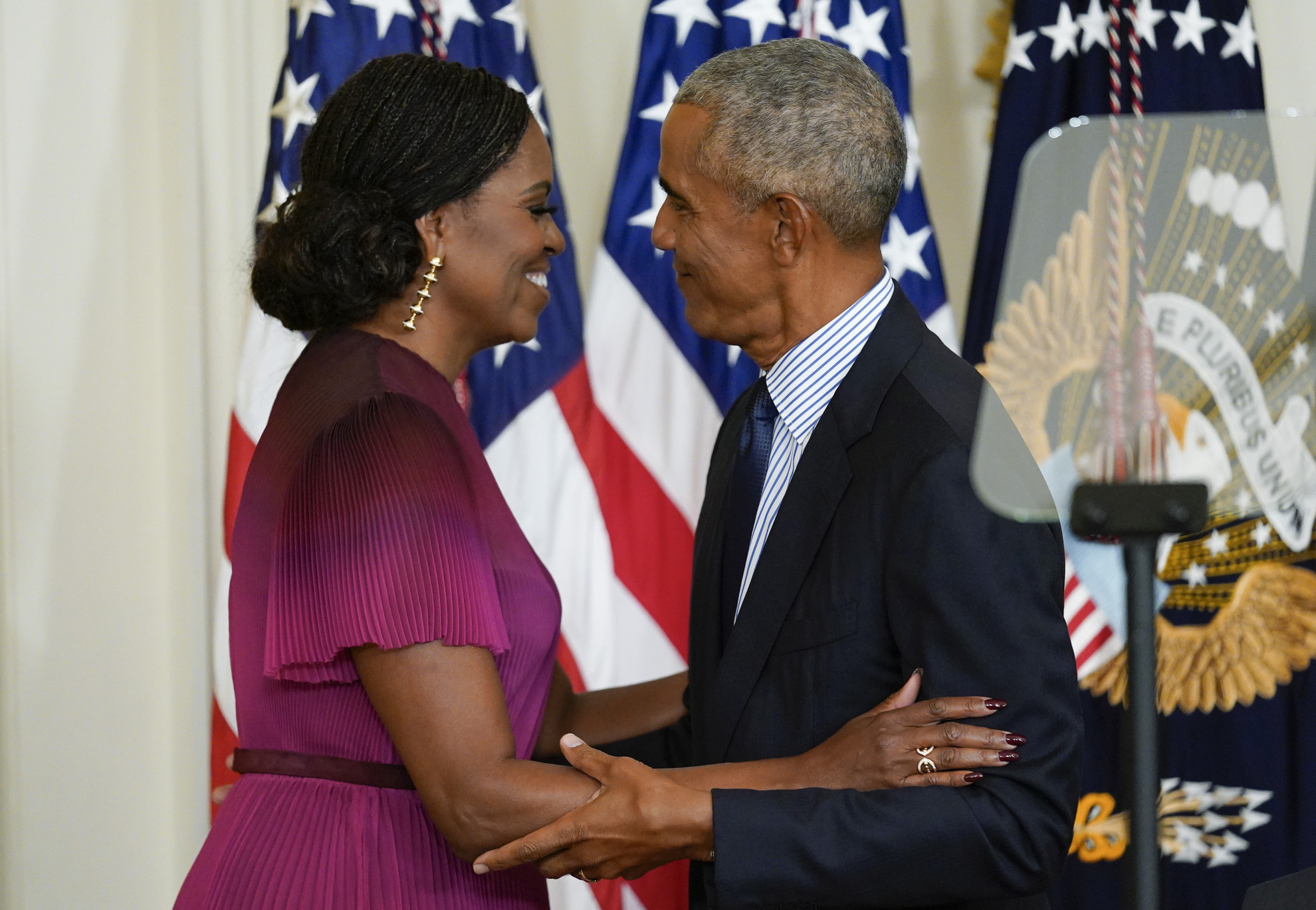 Former President Barack Obama looks at former first lady Michelle Obama
