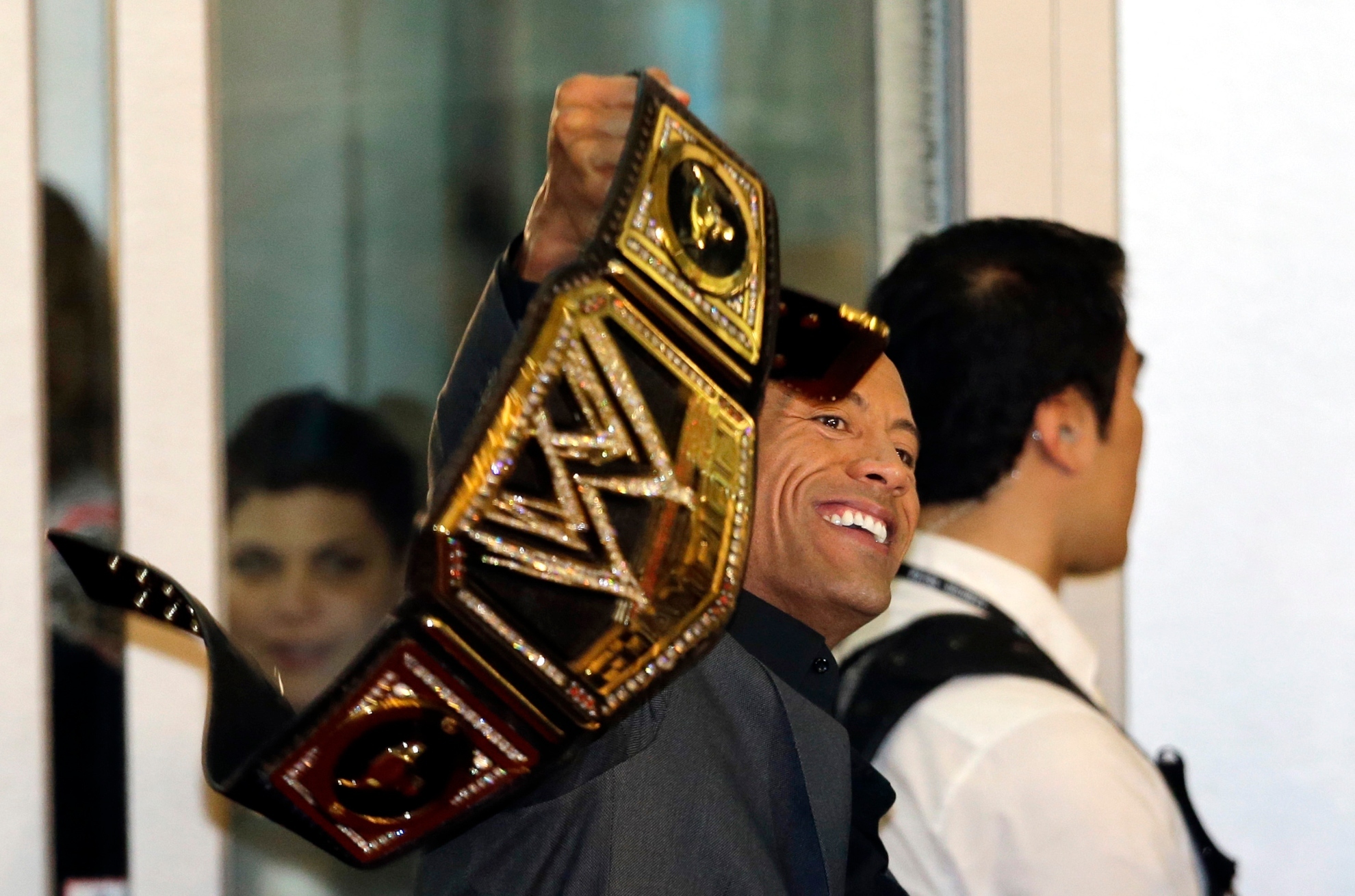U.S. actor and professional wrestler Dwayne Johnson holds a his champion belt during the world premiere event of his new film G. I. Joe: Retaliation in Seoul, South Korea, Monday, March 11, 2013. Johnson is here to promote the film which is to be released in South Korea on March 28.