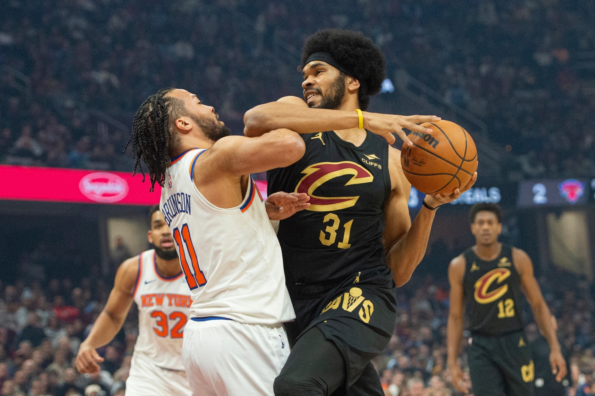 Cleveland Cavaliers Jarrett Allen (31) is fouled by New York Knicks Jalen Brunson (11) during the first half of an NBA basketball game in Cleveland, Friday, Feb. 21, 2025.