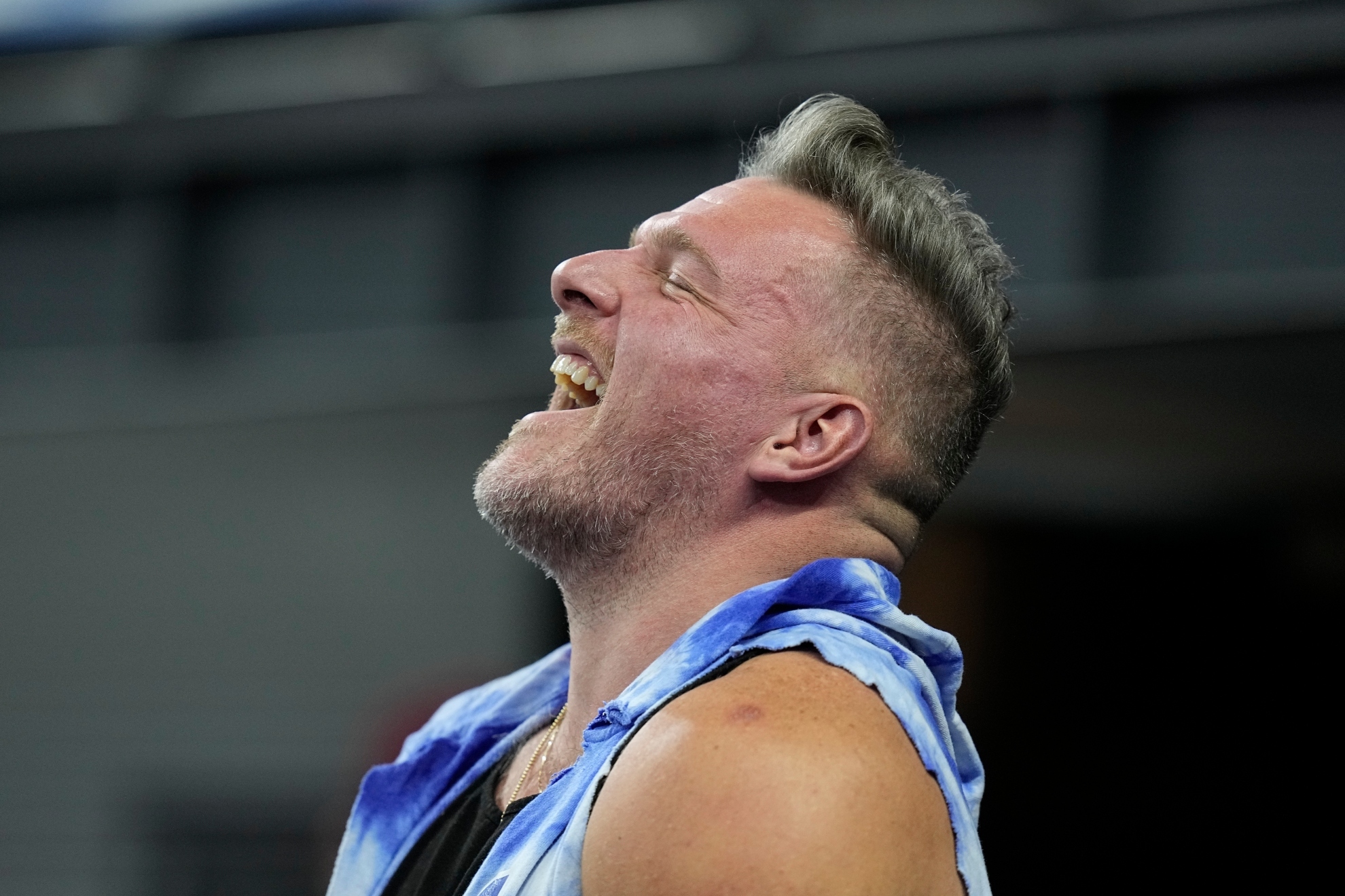 Pat McAfee smiles on the field before an NFL game.