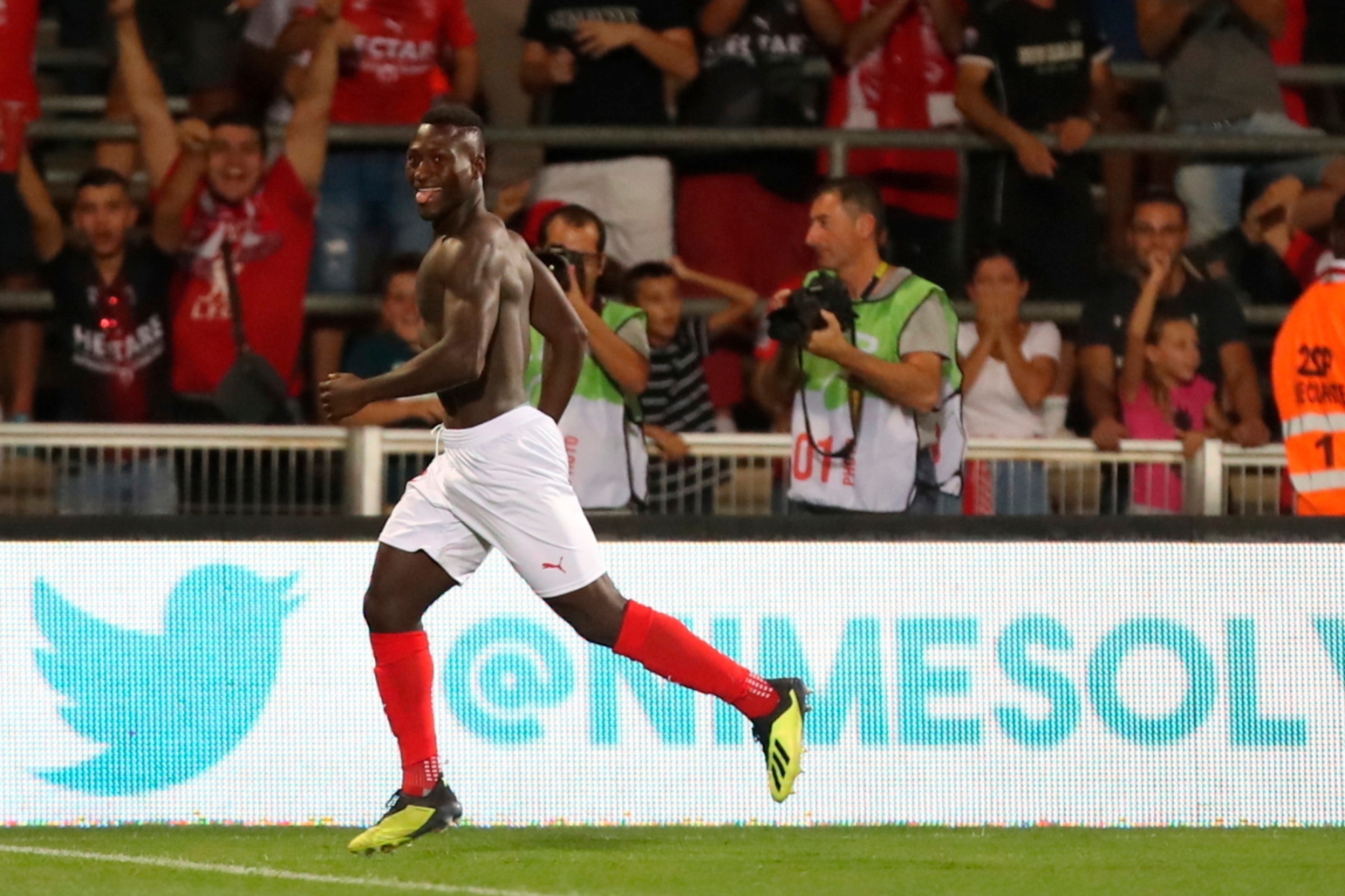 Nimes Kevin Denkey celebrates after scoring during the French League One soccer match between Nimes and Brest at the Stade des Costi�res in Nimes, southern France, Saturday, Aug. 31, 2019.