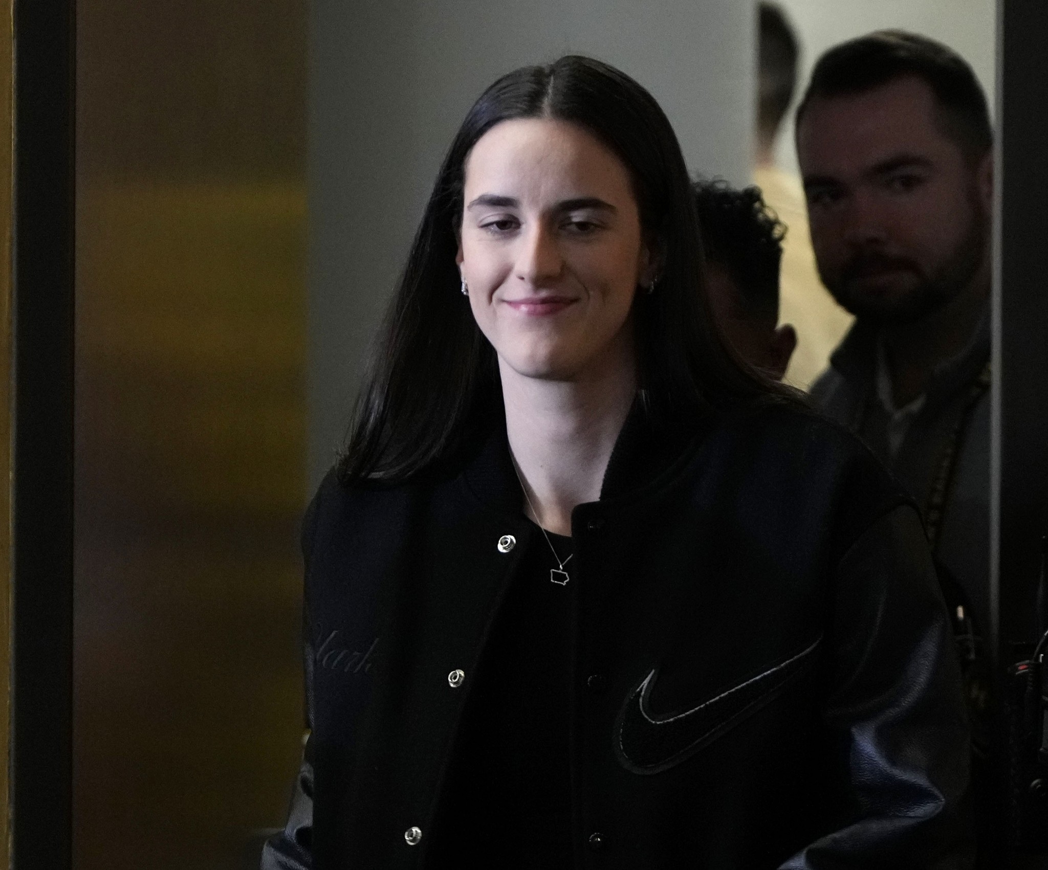 Indiana Fever player Caitlin Clark arrives at a news conference in a game between Iowa and USC