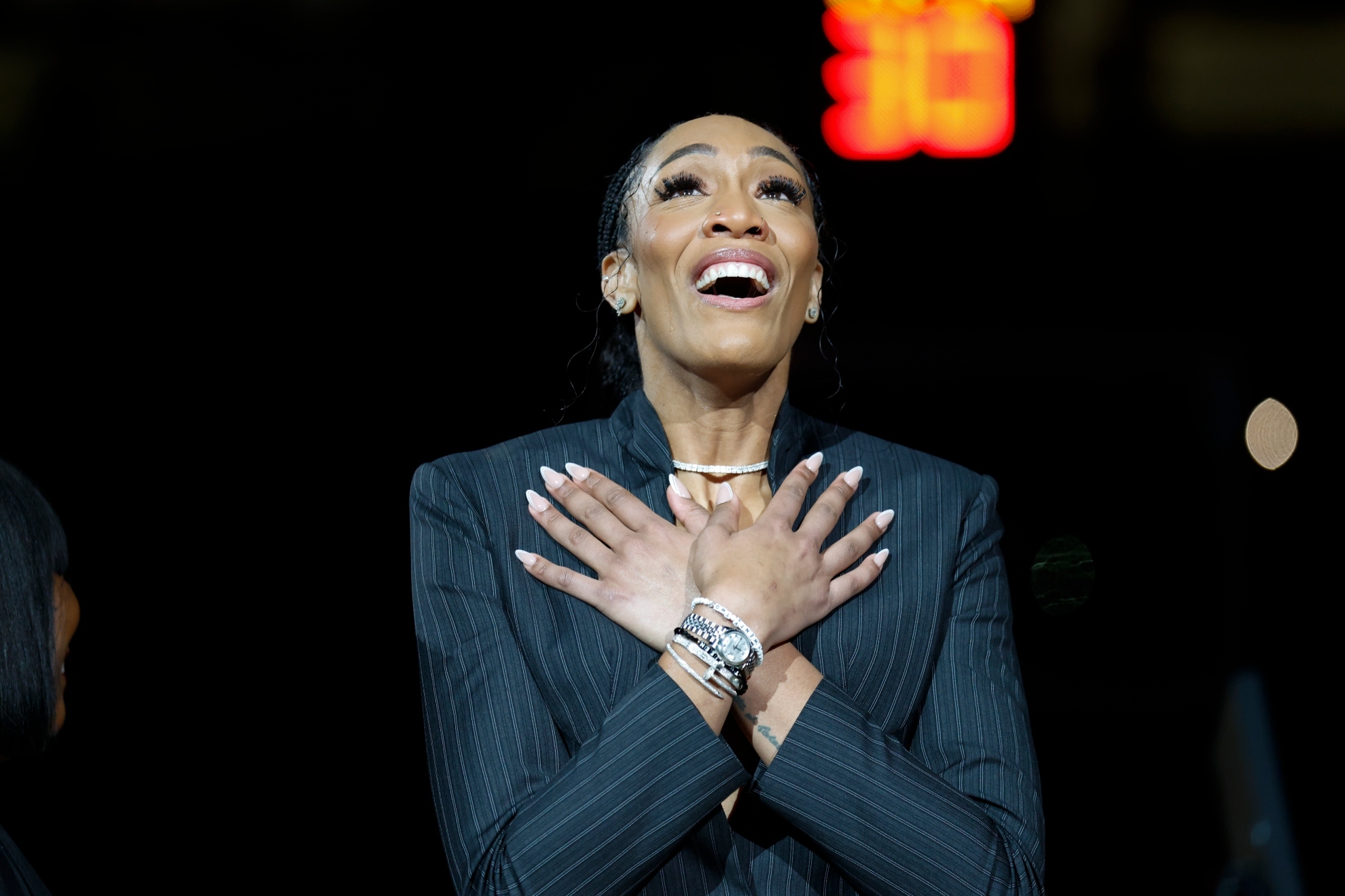 Aja Wilson attends a ceremony to retire her number before an NCAA college basketball game.