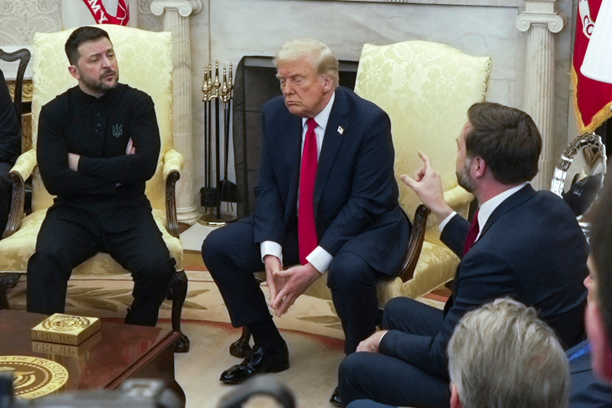 Vice President JD Vance, right, speaks with Ukrainian President Volodymyr Zelenskyy, left, as President Donald Trump listens in the Oval Office at the White House, Friday, Feb. 28, 2025, in Washington.