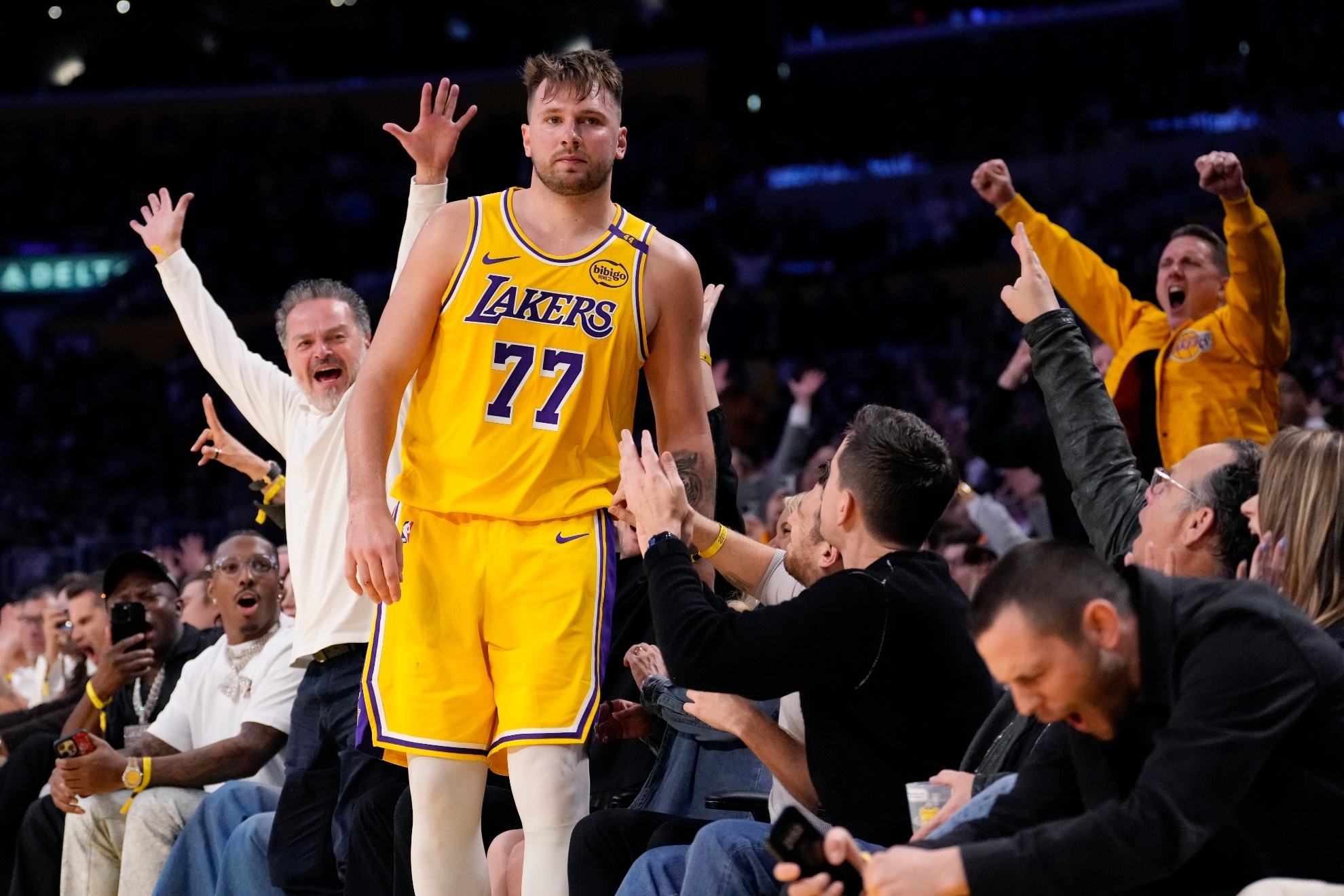 Los Angeles Lakers guard Luka Doncic is surrounded by fans after scoring during the second half of an NBA basketball game against the Minnesota Timberwolves, Thursday, Feb. 27, 2025, in Los Angeles.