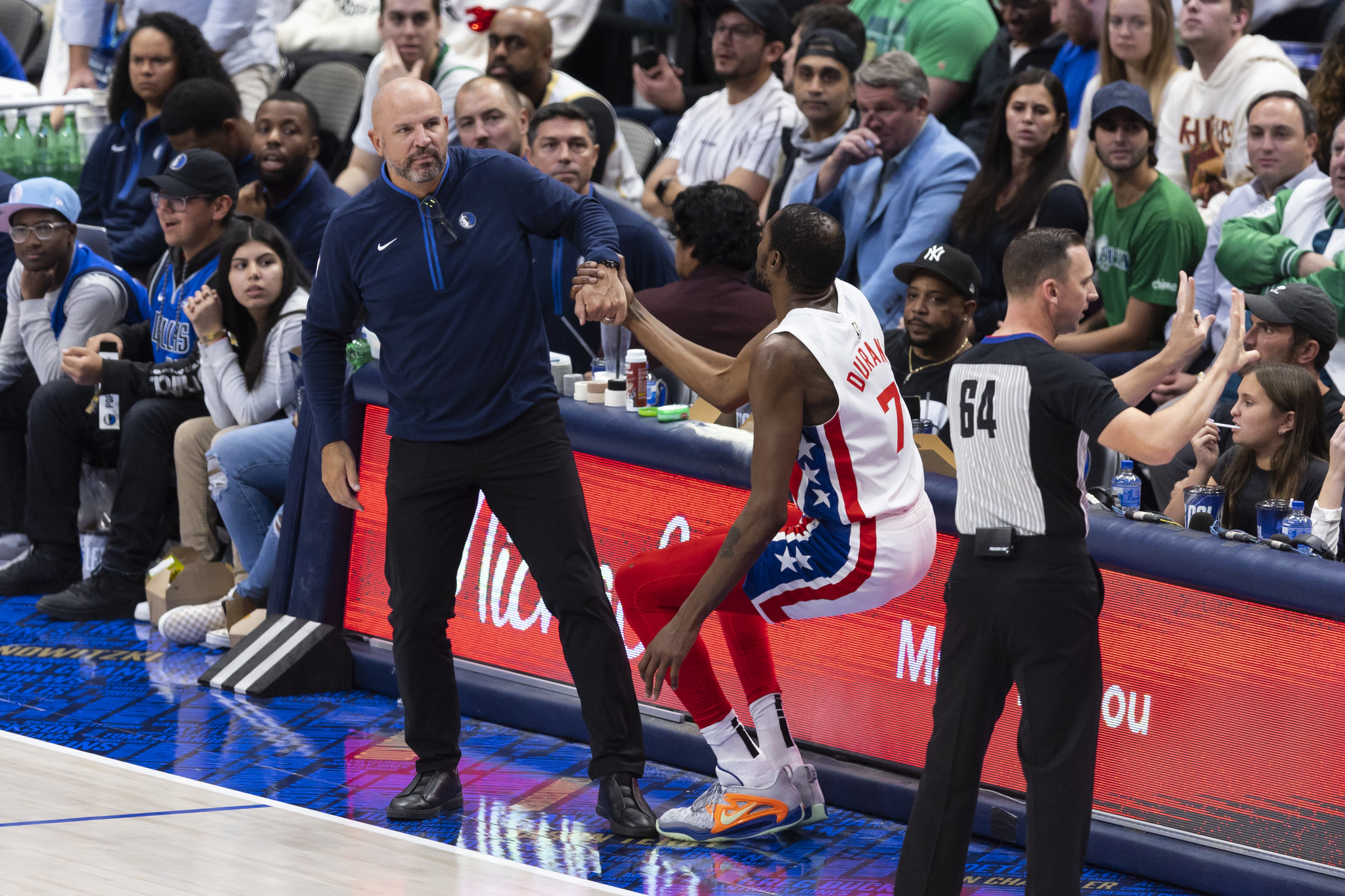 Dallas Mavericks coach Jason Kidd, left, helps up forward Kevin Durant (7)