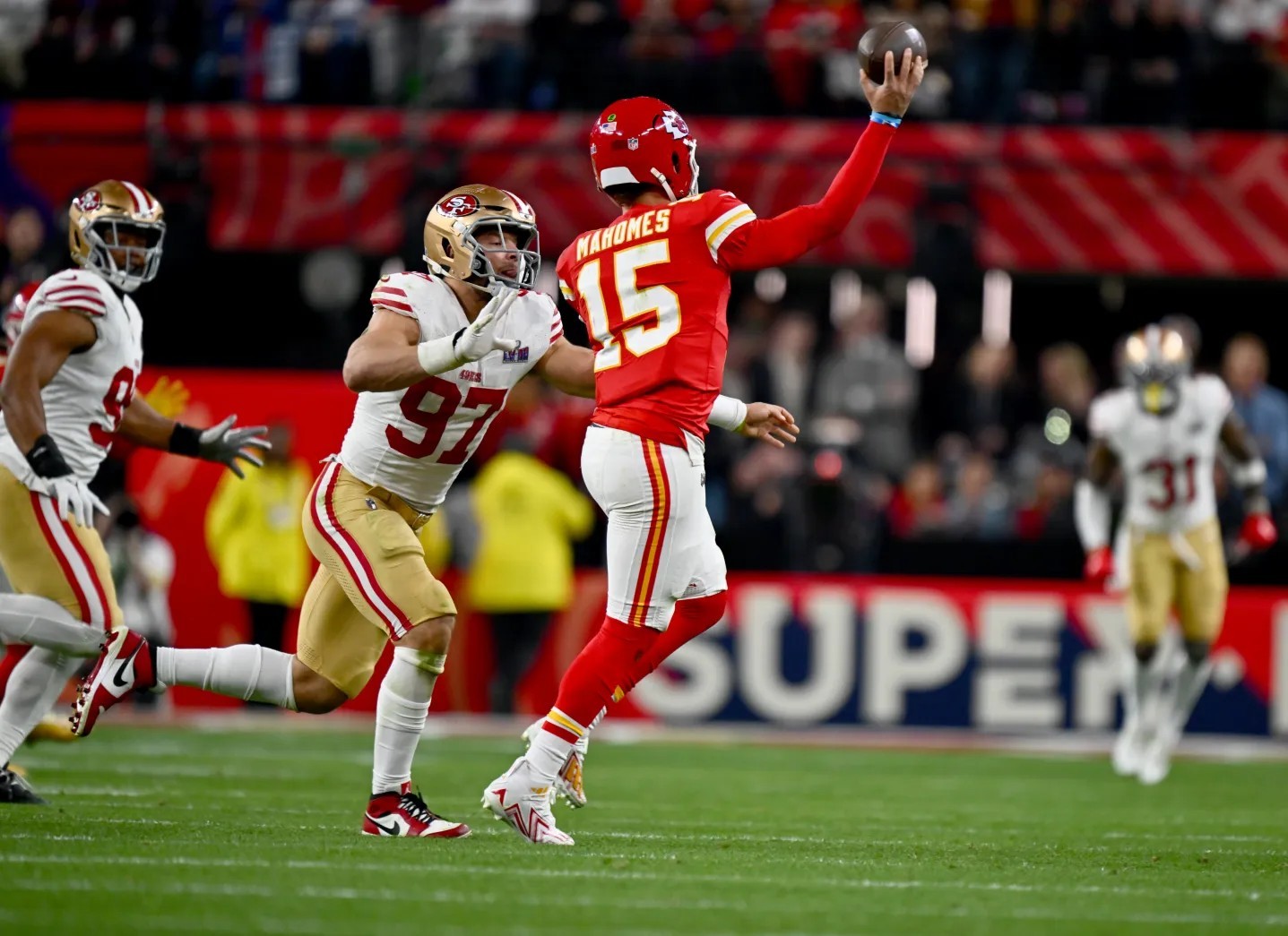 San Francisco 49ers Nick Bosa (97) pressures Kansas City Chiefs quarterback Patrick Mahomes (15)