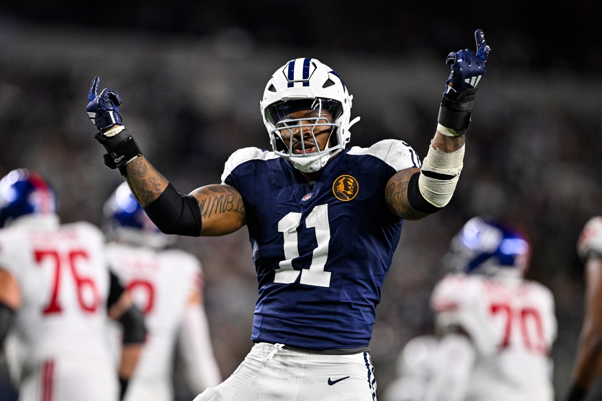 Micah Parsons celebrates a sack of New York Giants quarterback Drew Lock during the second half of an NFL game.