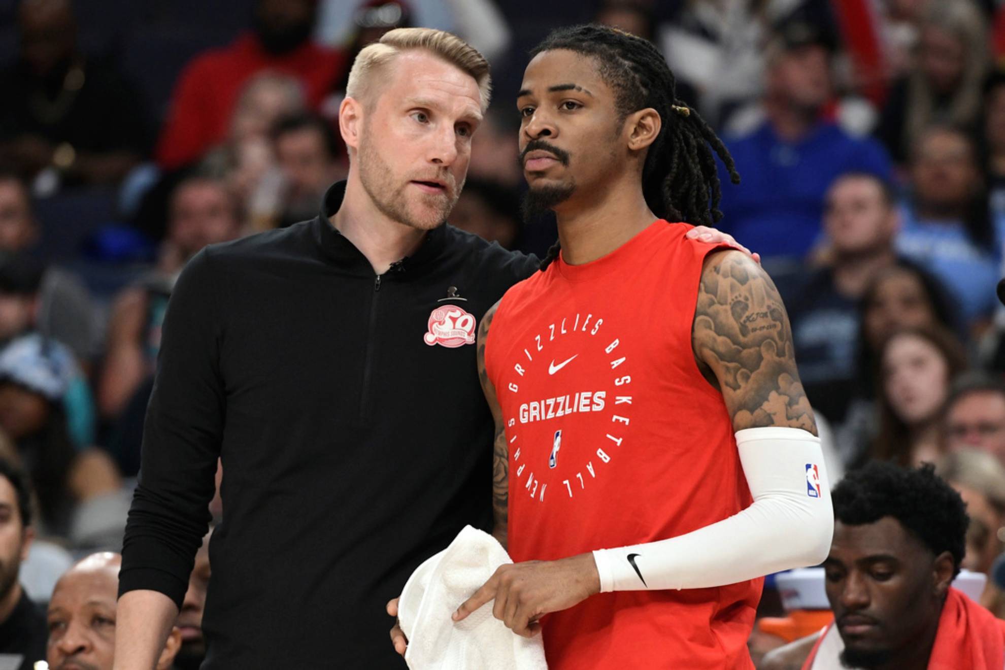 Memphis Grizzlies interim head coach Tuomas Iisalo talks with guard Ja Morant /