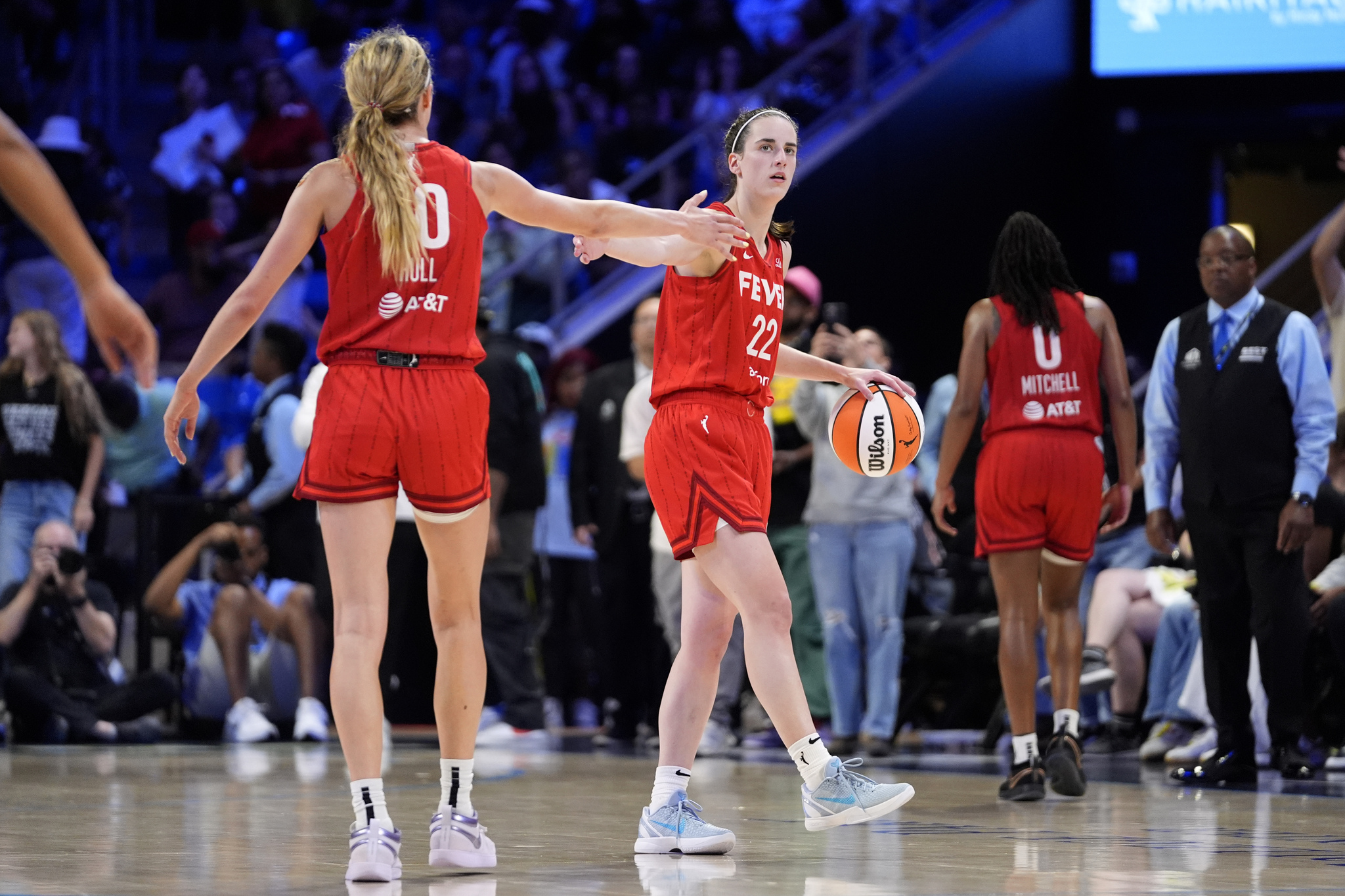 Indiana Fevers Lexie Hull (10) and Caitlin Clark, center, celebrate late in the second half of a WNBA basketball game against the Dallas Wings