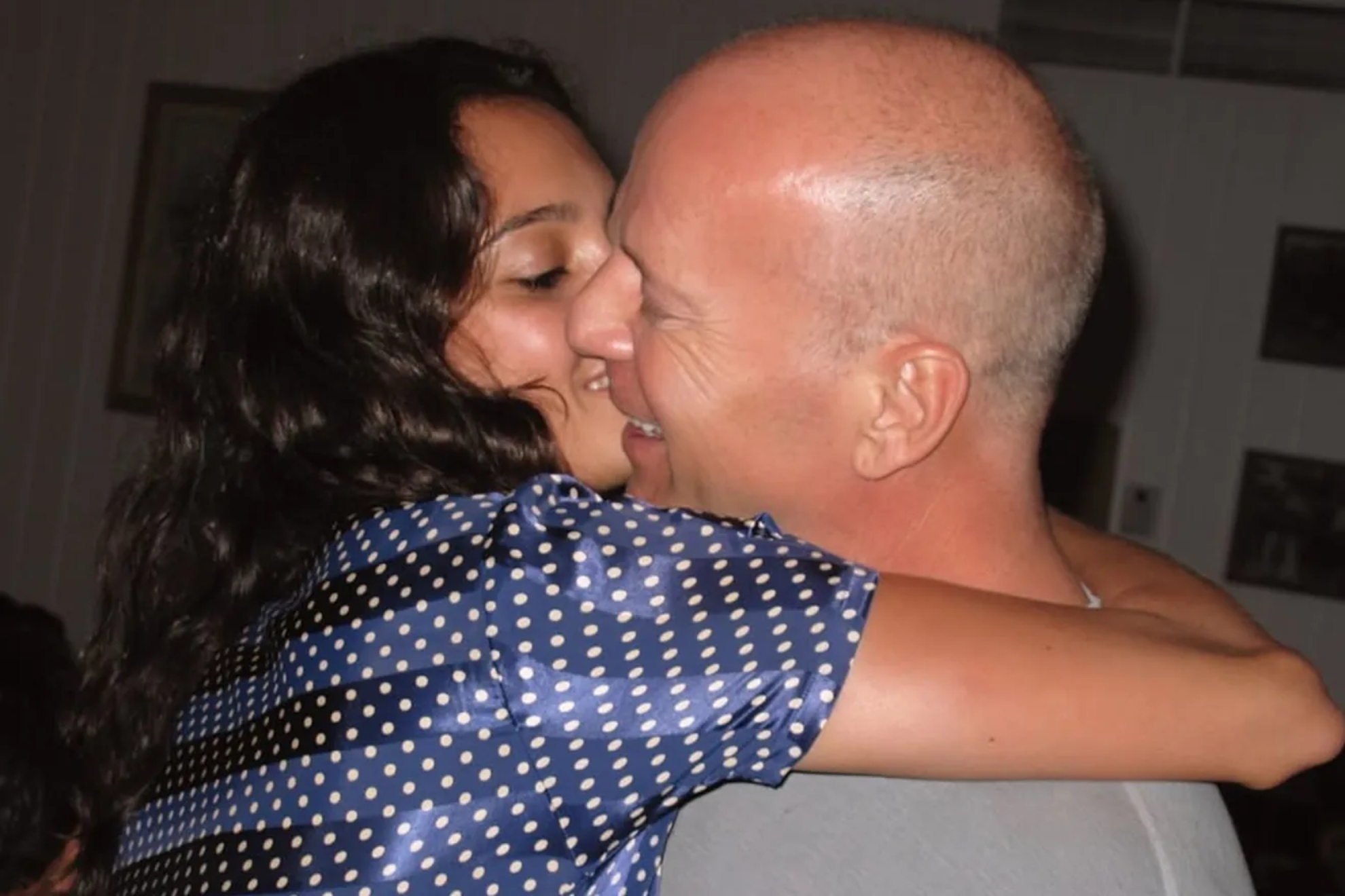 Emma Heming and Bruce Willis embrace.