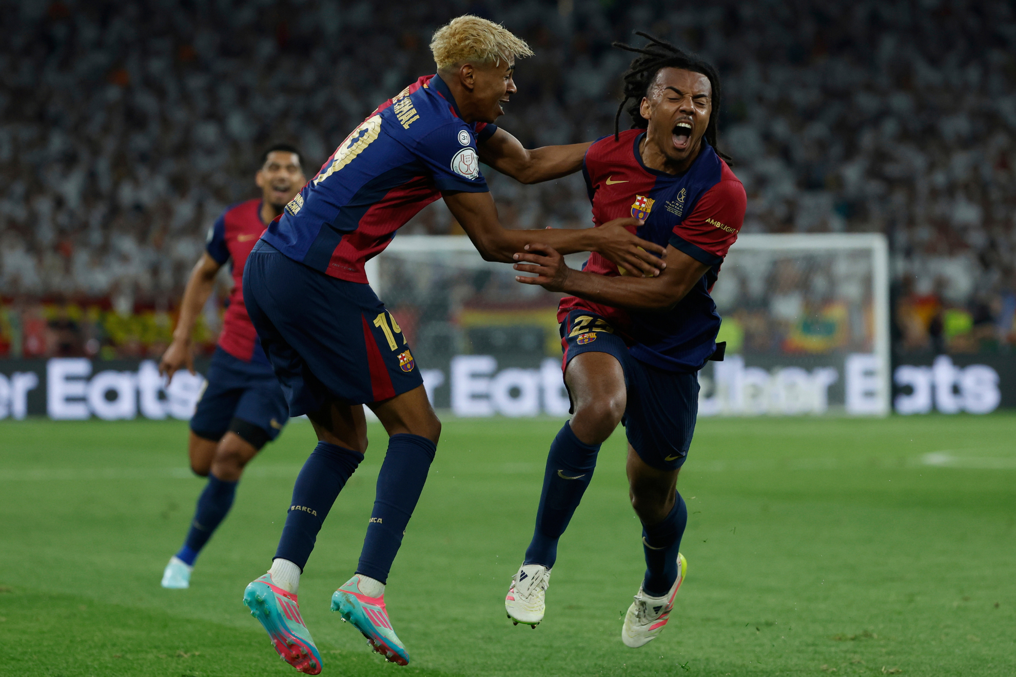 Jules Kounde and Lamine Yamal celebrate Barcelonas trophy-winning goal.