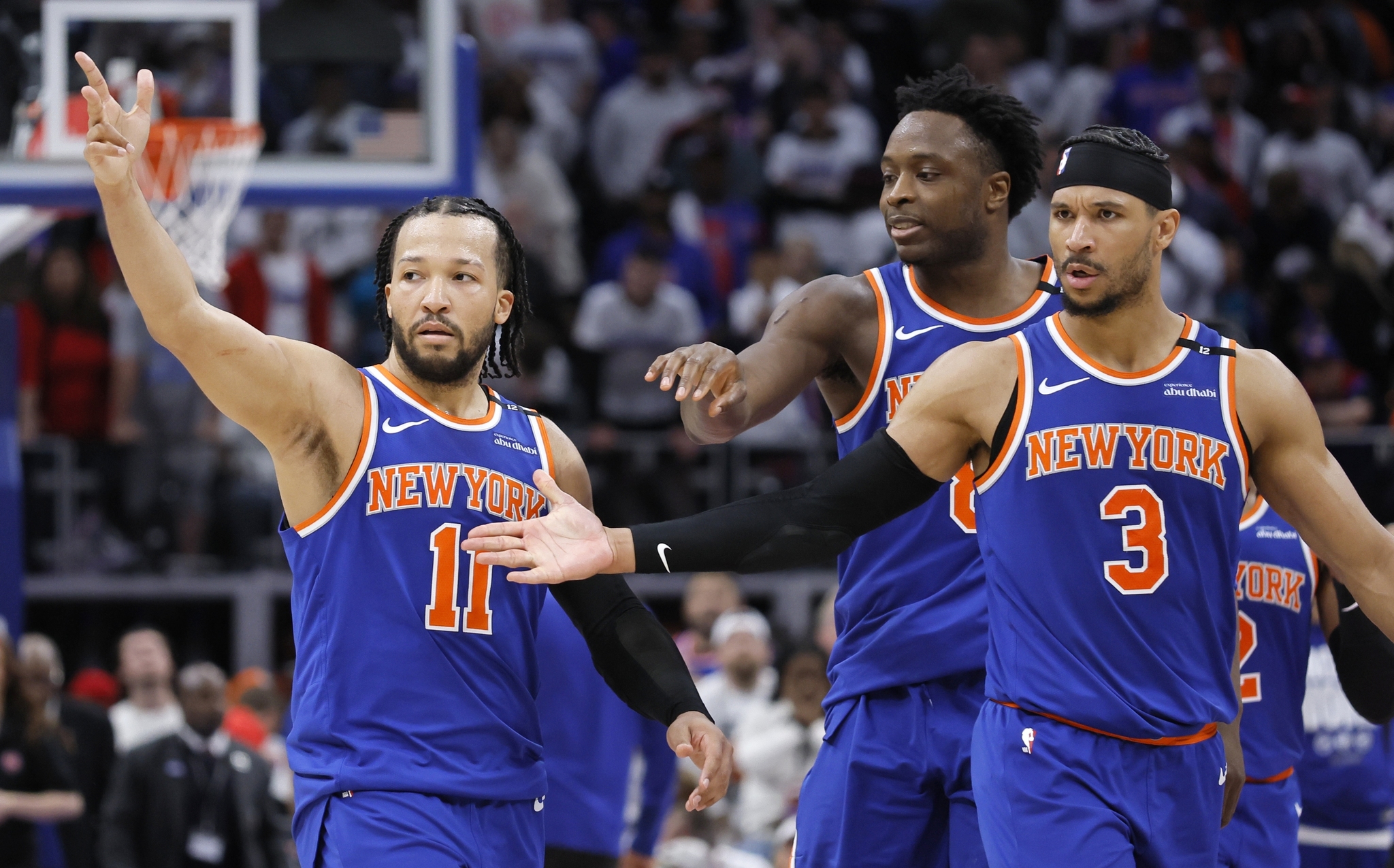 New York Knicks guard Jalen Brunson (11) celebrates with forward OG Anunoby, center, and guard Josh Hart (3) after scoring the winning basket
