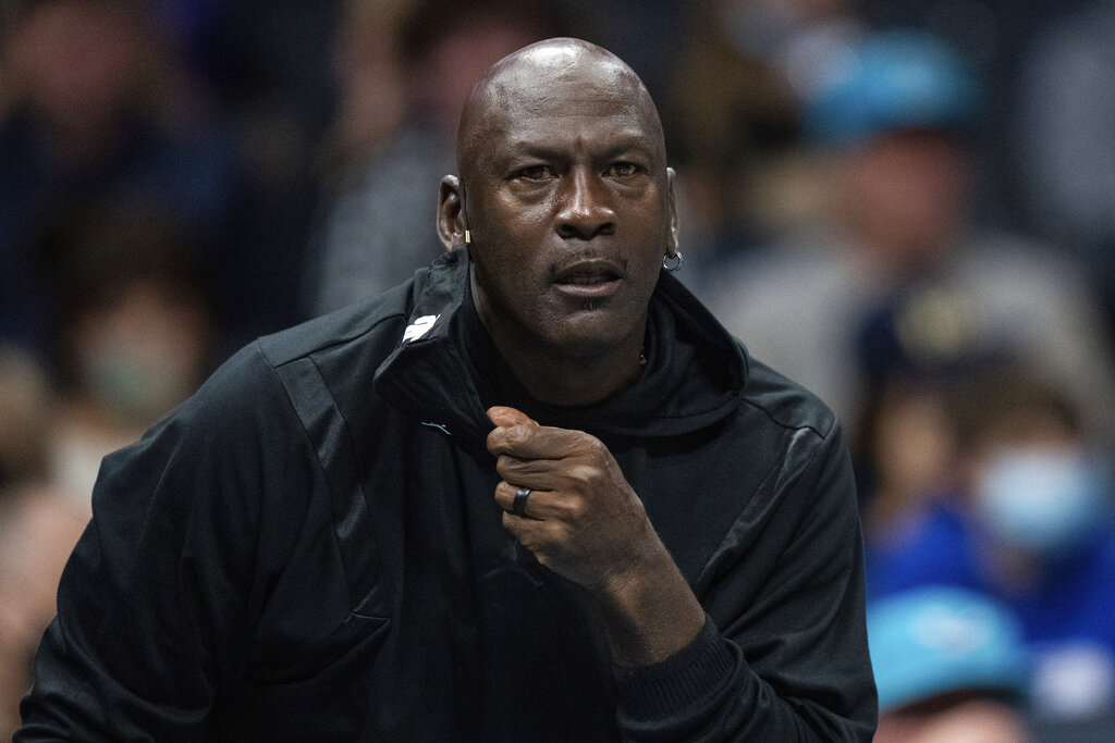 Michael Jordan looks on during the first half of an NBA basketball game between the Charlotte Hornets and the New York Knicks in Charlotte, N.C., Friday, Nov. 12, 2021. (AP Photo/Jacob Kupferman)