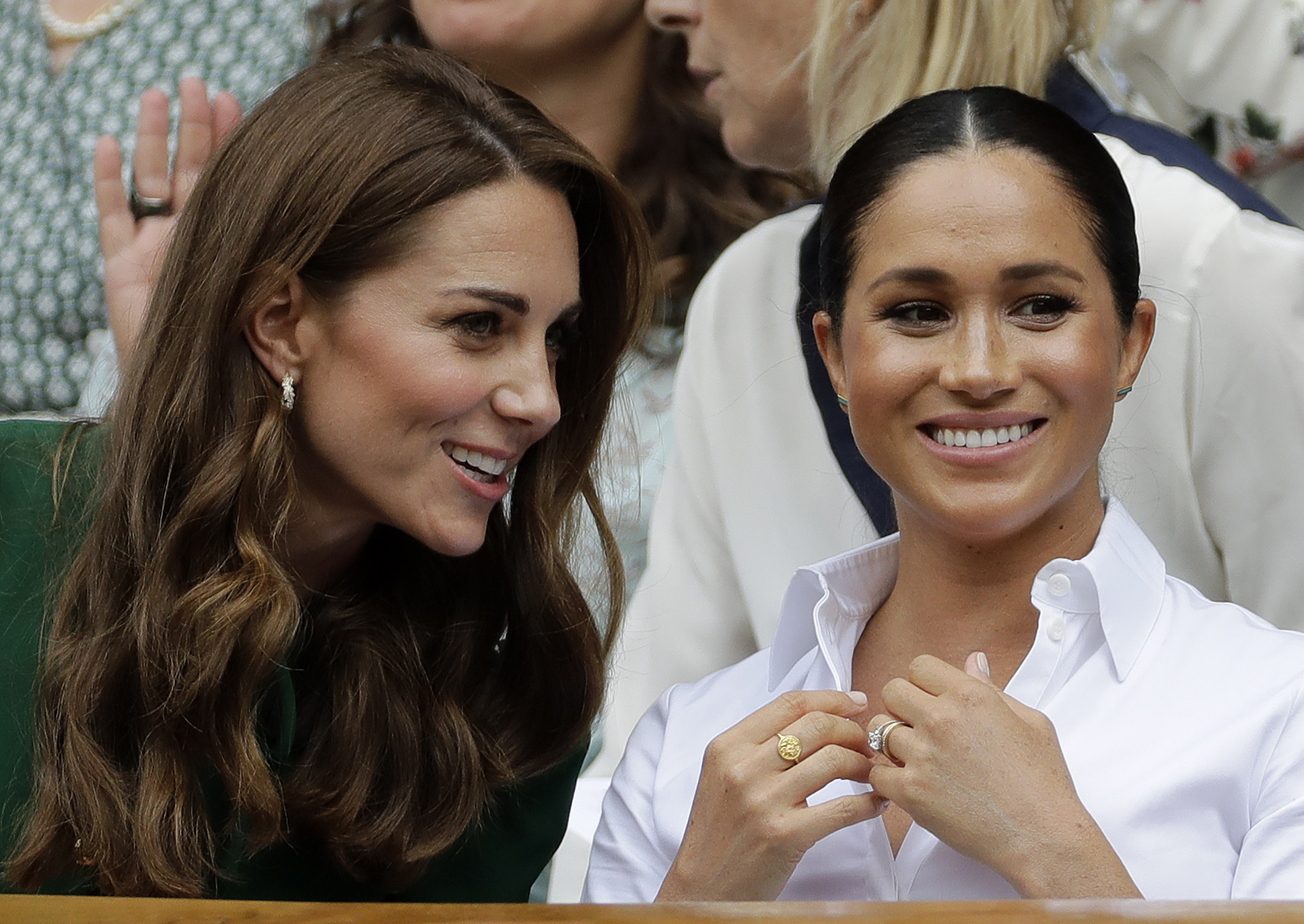 Britains Kate, Duchess of Cambridge, left, and Meghan, Duchess of Sussex speak as they sit in the Royal Box on Centre Court to watch the womens singles final match between Serena Williams of the United States and Romanias Simona Halep on day twelve of the Wimbledon Tennis Championships in London, July 13, 2019