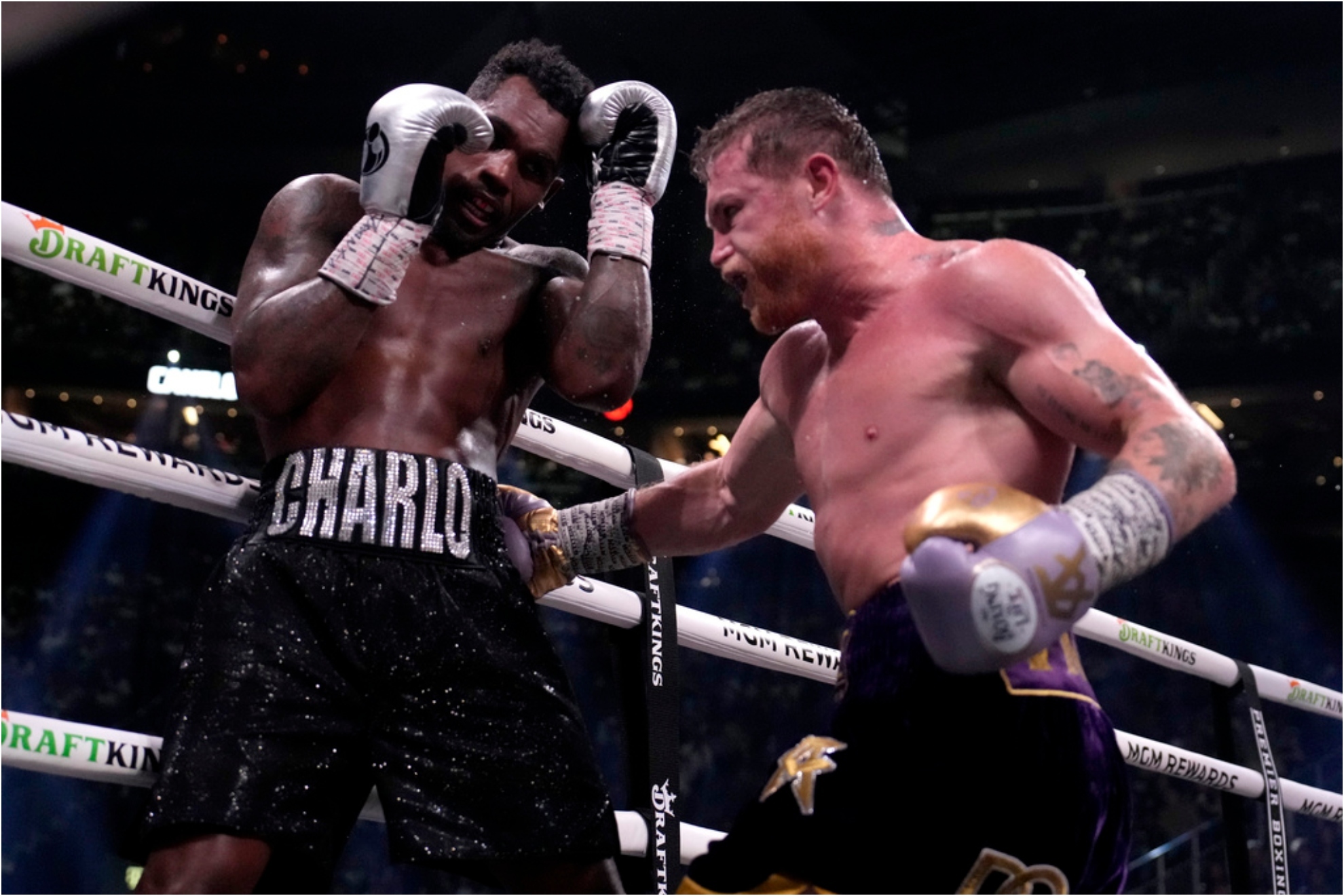 Canelo Alvarez, of Mexico, right, fights Jermell Charlo in a super middleweight title boxing match.