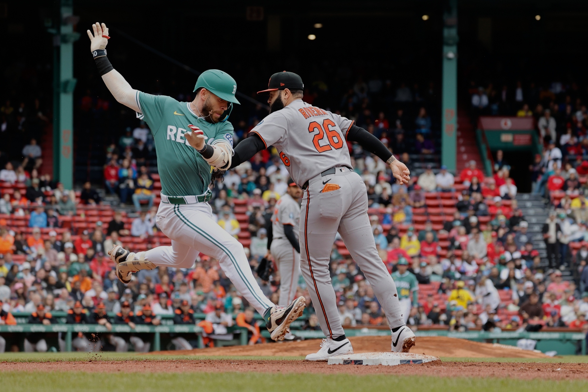 Boston Red Soxs Trevor Story, left, is tagged out at first by Baltimore Orioles first baseman Emmanuel Rivera.