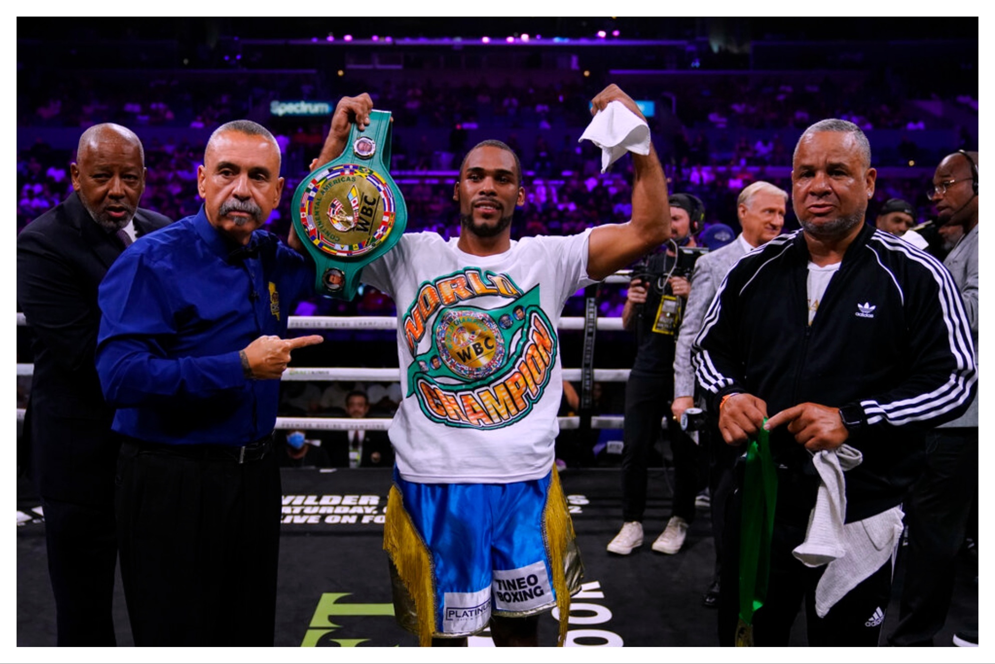 Edwin De Los Santos, center, celebrates after winning in a WBC continental americas lightweight championship boxing match against Jose Valenzuela.