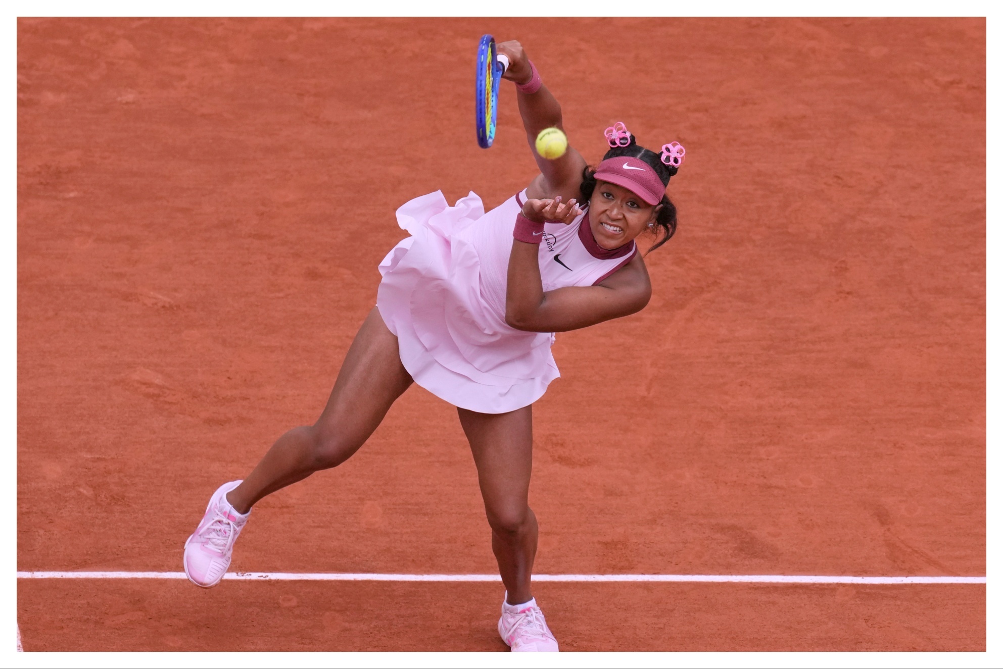 Japans Naomi Osaka returns the ball to Spains Paula Badosa during their first round match of the French Tennis Open, at the Roland-Garros stadium, in Paris.
