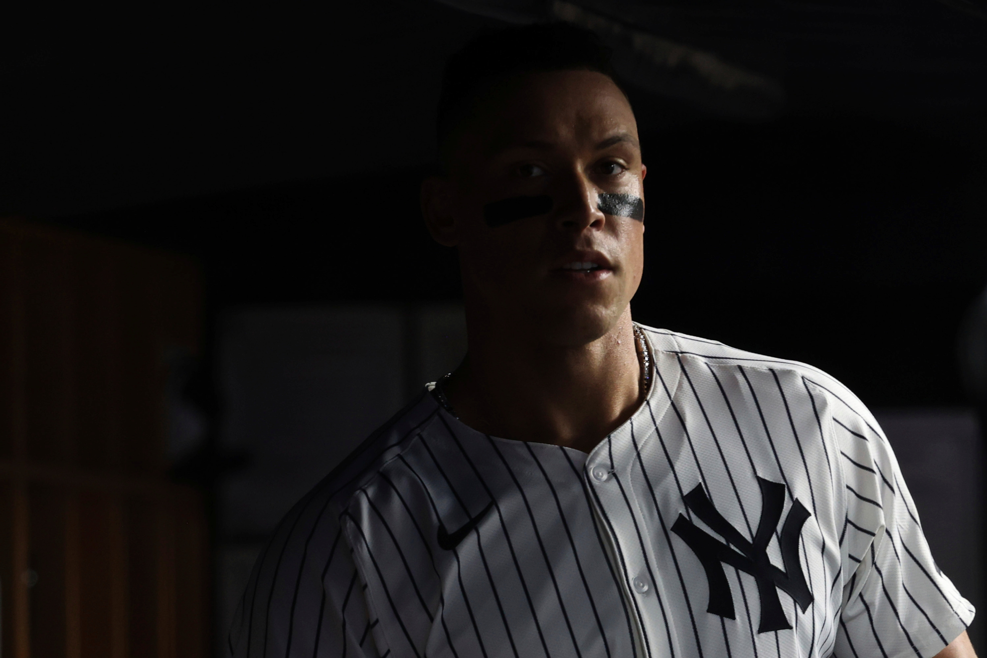 New York Yankees Aaron Judge stands in the dugout during the sixth inning of a baseball game against the Los Angeles Angels, Tuesday, June 17, 2025, in New York.