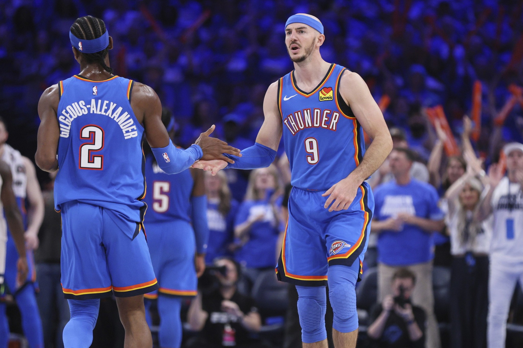 Oklahoma City Thunder guards Shai Gilgeous-Alexander (2) and Alex Caruso (9) high-five during the NBA playoffs