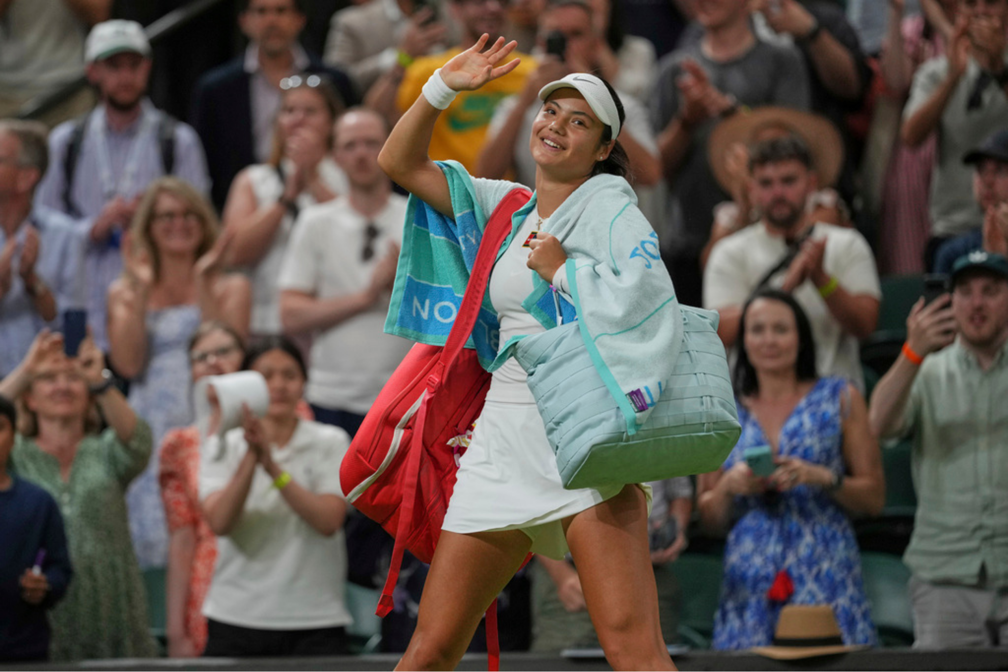 Emma Raducanu of Britain waves as she leaves the court after losing to Aryna Sabalenka