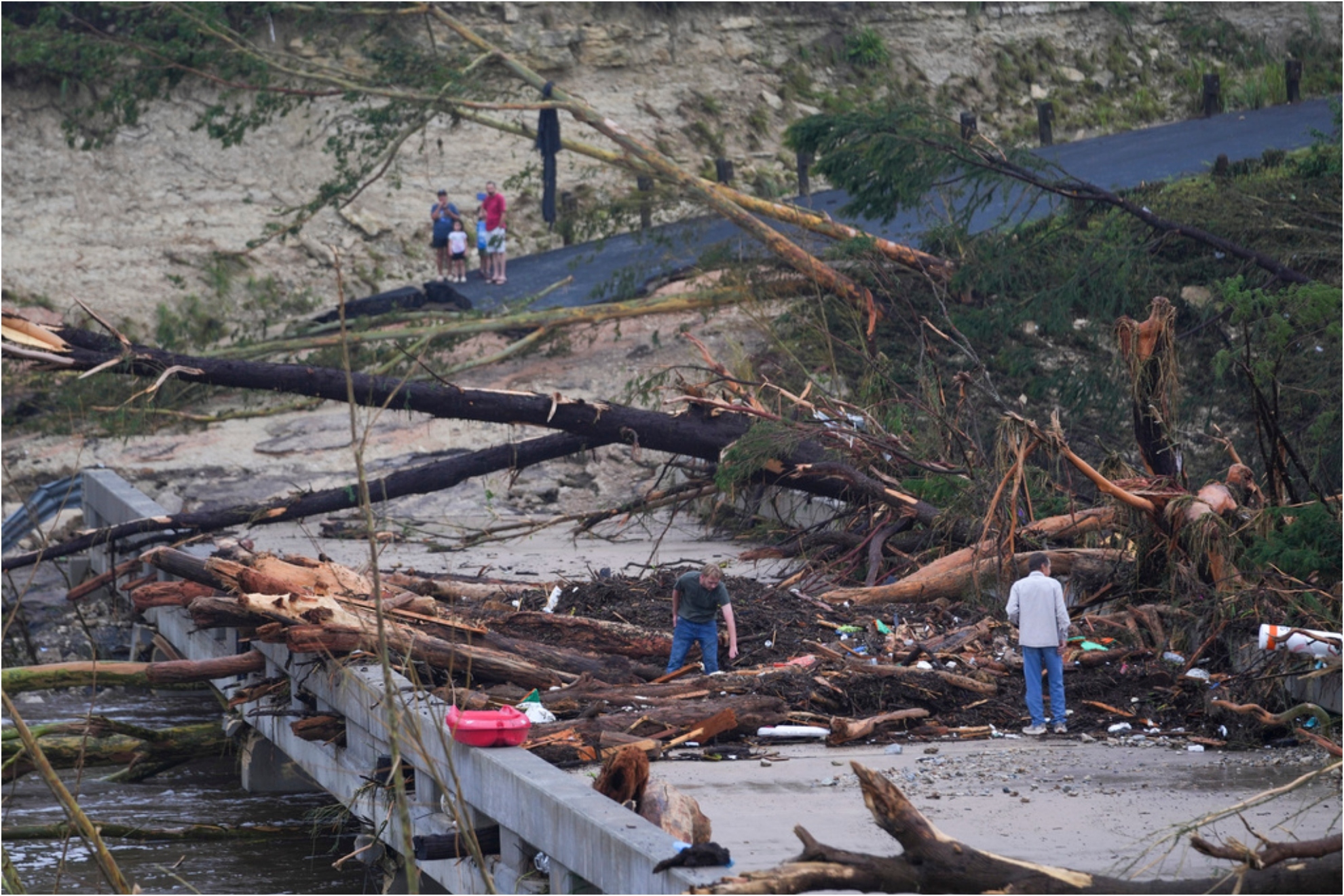 Debris rests on a bridge over the Guadalupe River after a flash flood swept through the area.