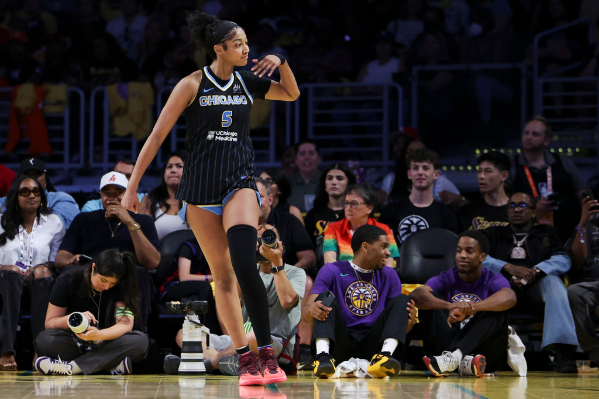 Chicago Sky forward Angel Reese gestures towards the crowd after scoring