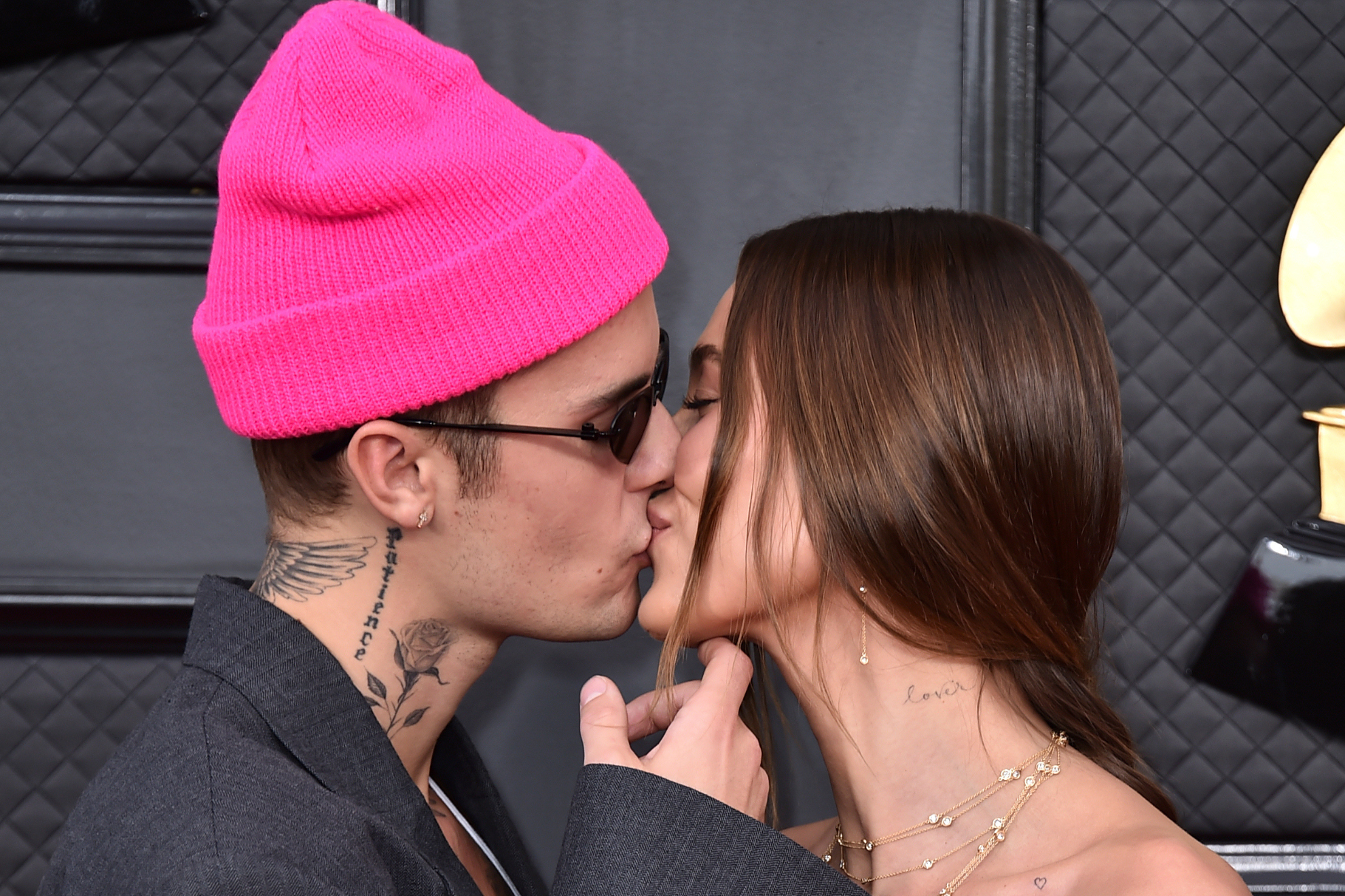 Justin Bieber kisses Hailey Bieber on the red carpet of the 2022 Grammys.