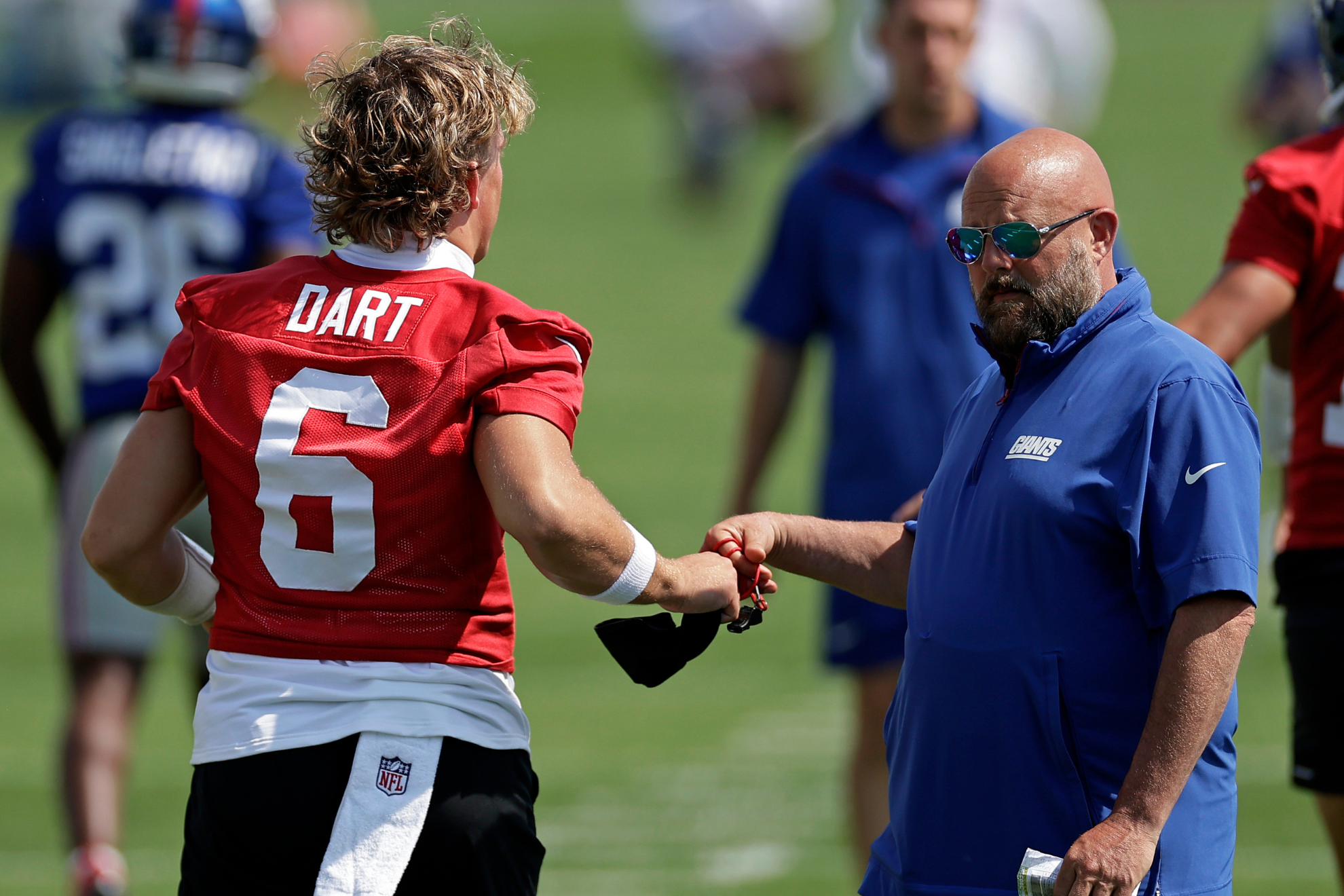 Jaxson Dart and Brian Daboll greet each other during New York Giants minicamp practice.