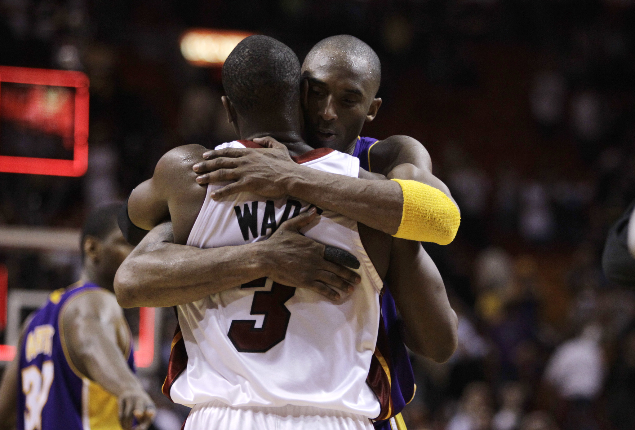 Miami Heat guard Dwyane Wade (3) is hugged by Los Angeles Lakers guard Kobe Bryant following an NBA basketball game in Miami