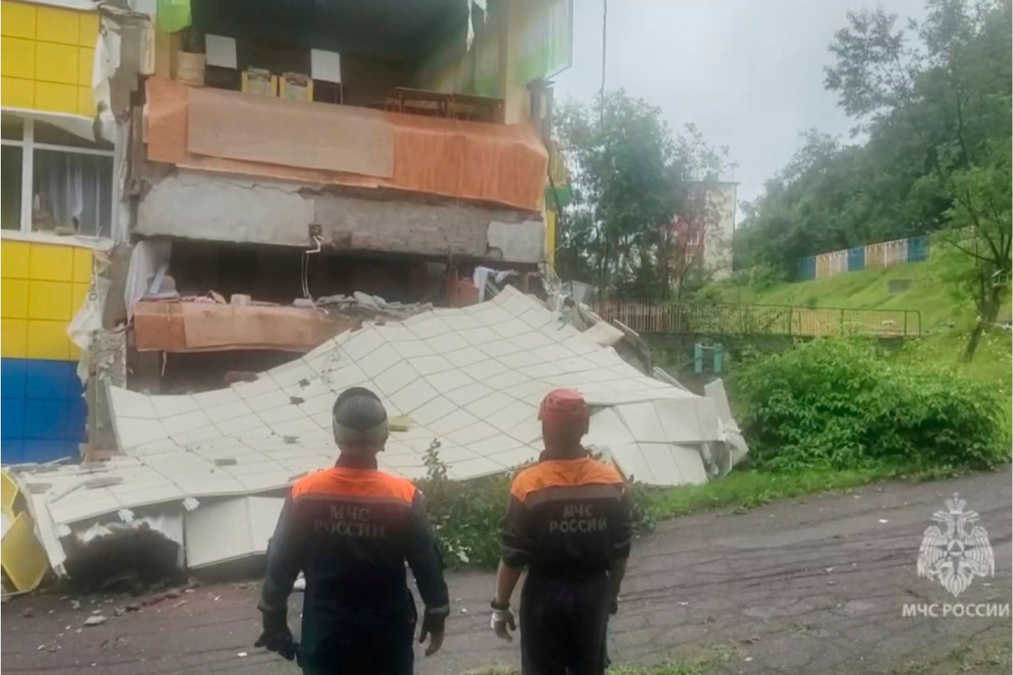 In this image taken from a video released by Russian Emergency Ministry Press Service, rescuers inspect a kindergarten damaged by an earthquake in Petropavlovsk-Kamchatsky, Russia