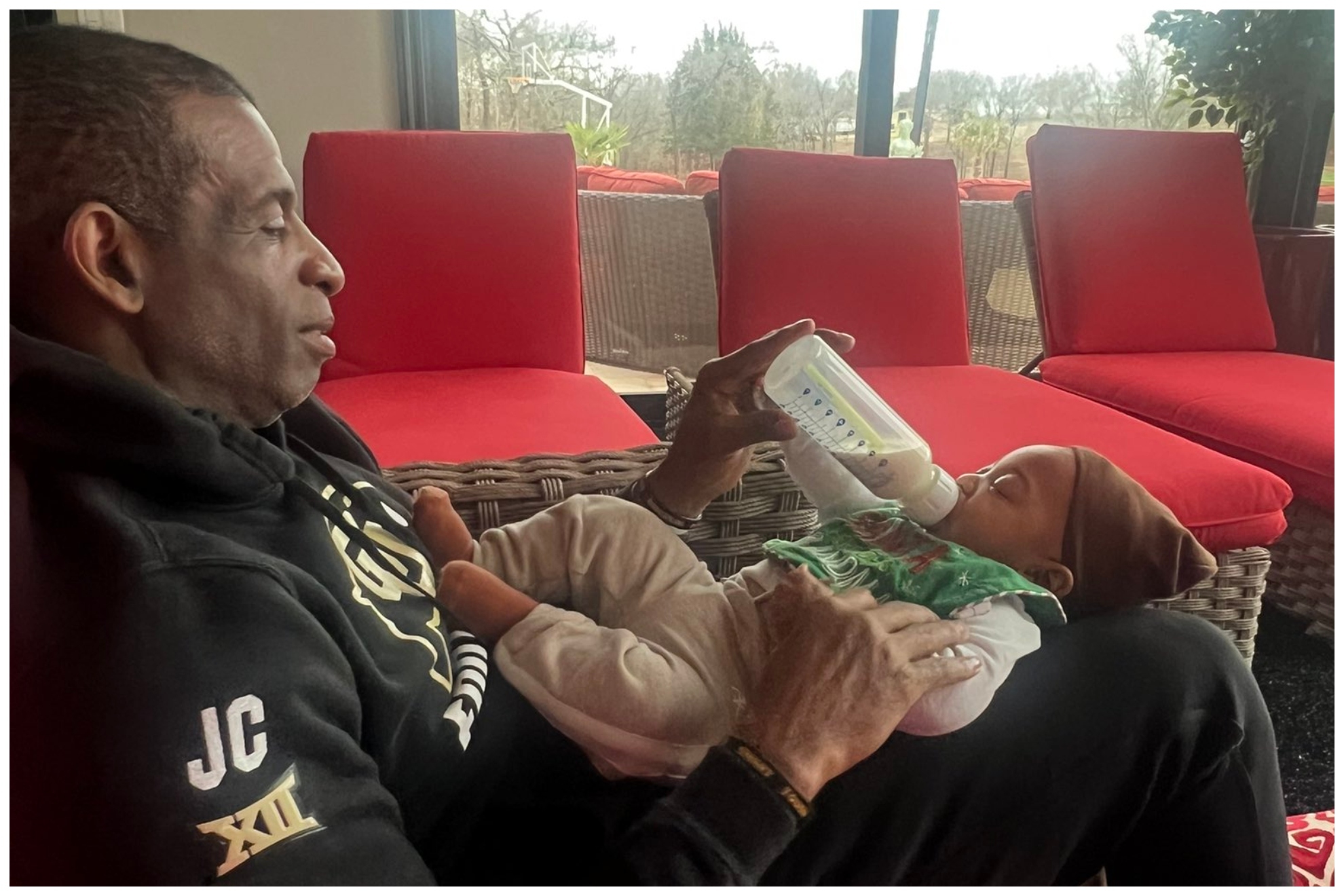 Deion Sanders with his grandson, Snow