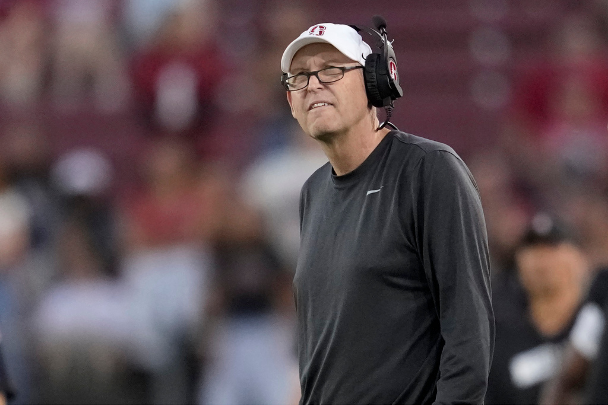 Former Stanford head coach Troy Taylor reacts as he watches the video board