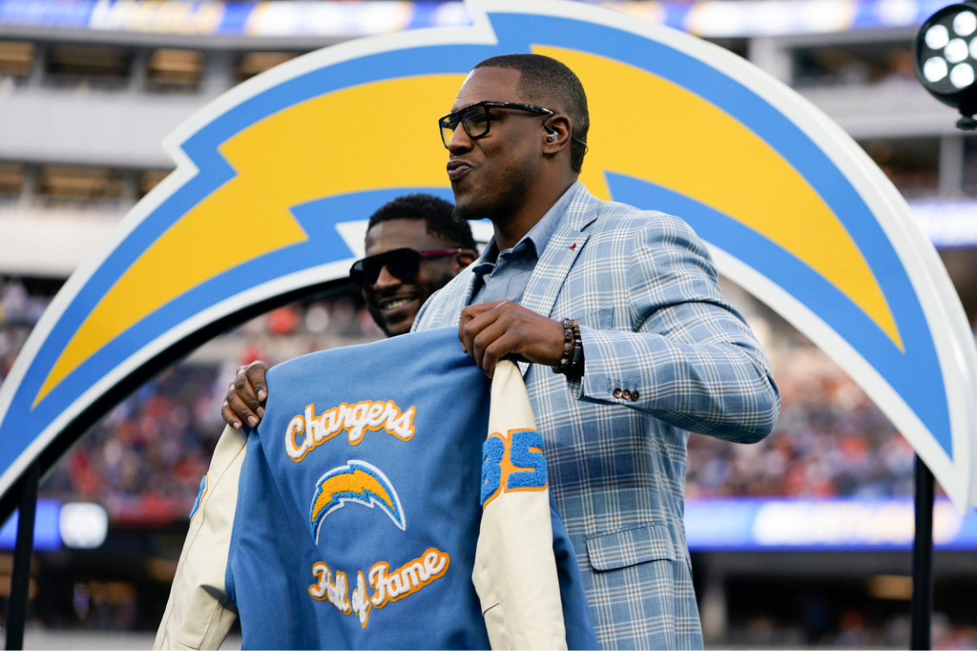 Former Los Angeles Chargers tight end Antonio Gates holds up a jacket