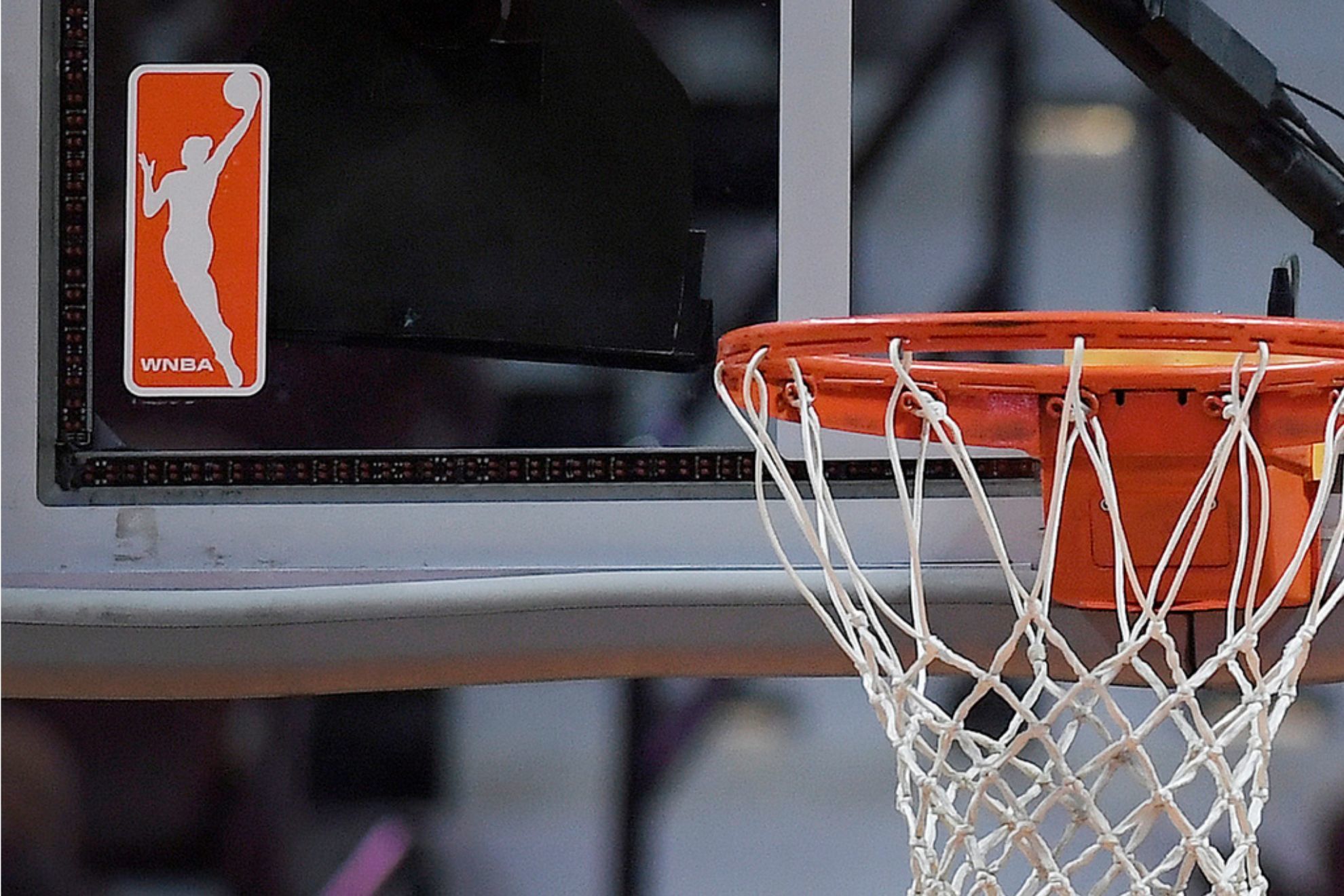 The WNBA logo is seen near a hoop before an WNBA basketball game at Mohegan Sun Arena