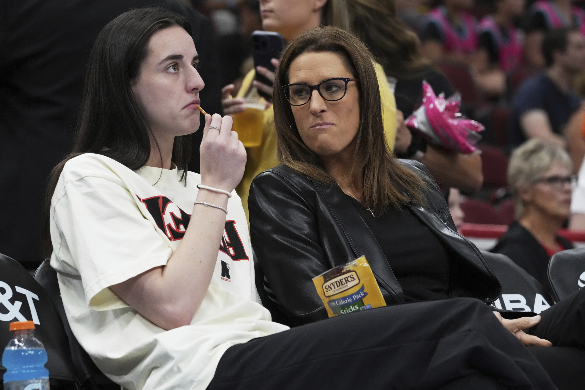 Indiana Fever head coach Stephanie White, right, talks with guard Caitlin Clark, left, before a WNBA basketball game against the Chicago Sky