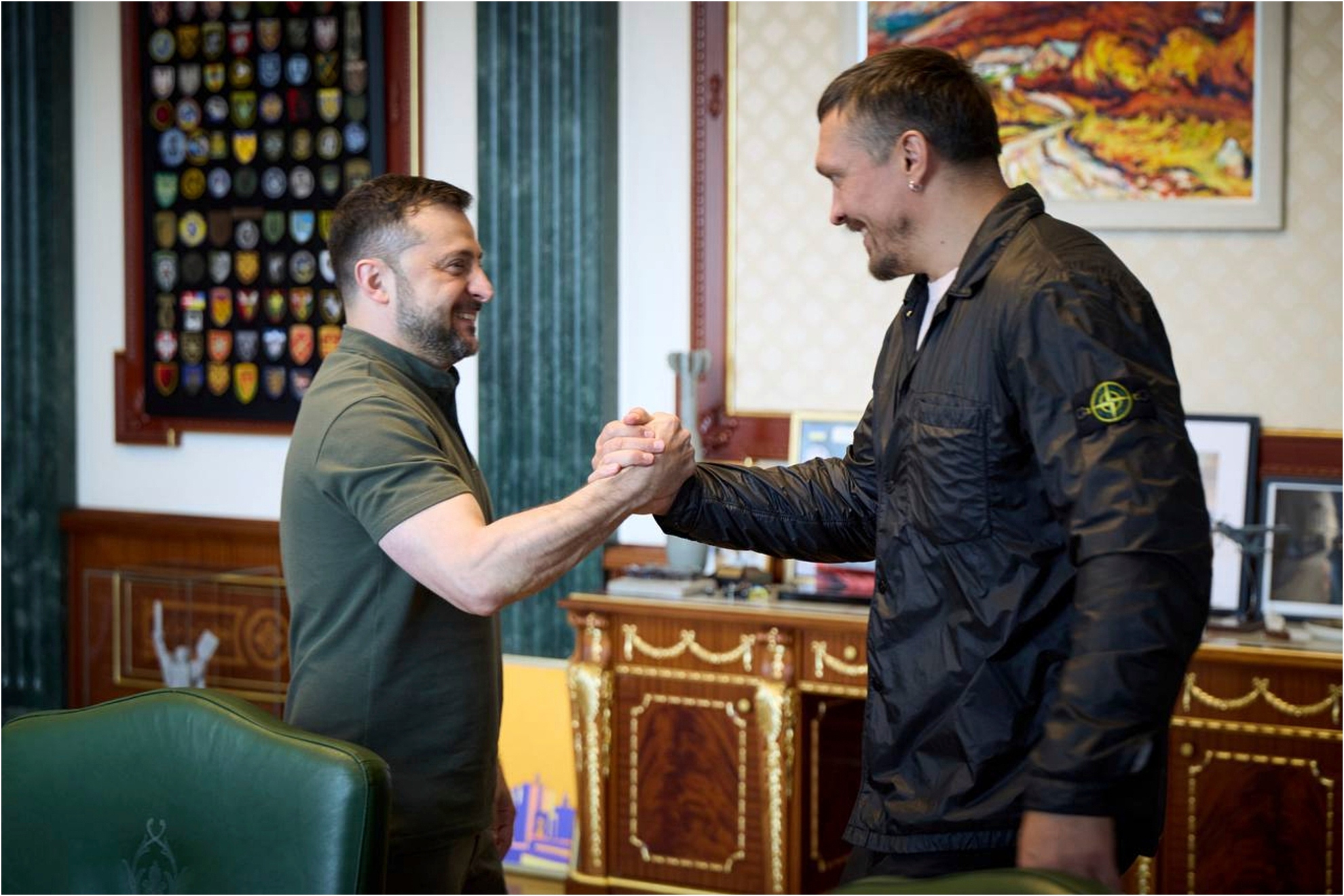 The Ukrainian President Zelenskyy, left, shakes hands with world heavyweight boxing champion Oleksandr Usyk.
