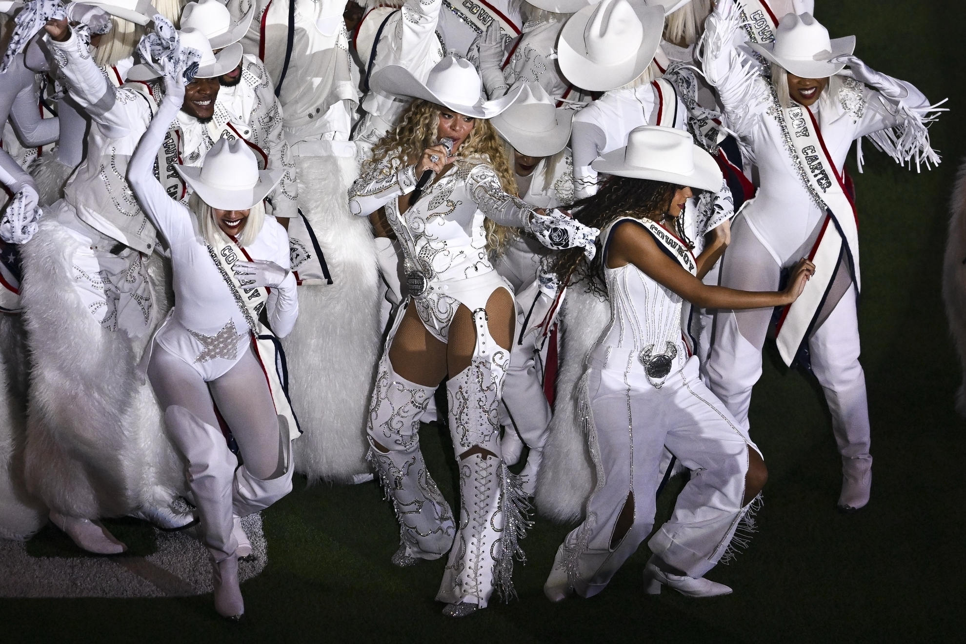 Beyonc�, center, is joined by her daughter Blue Ivy, right, during a halftime performance in an NFL football game