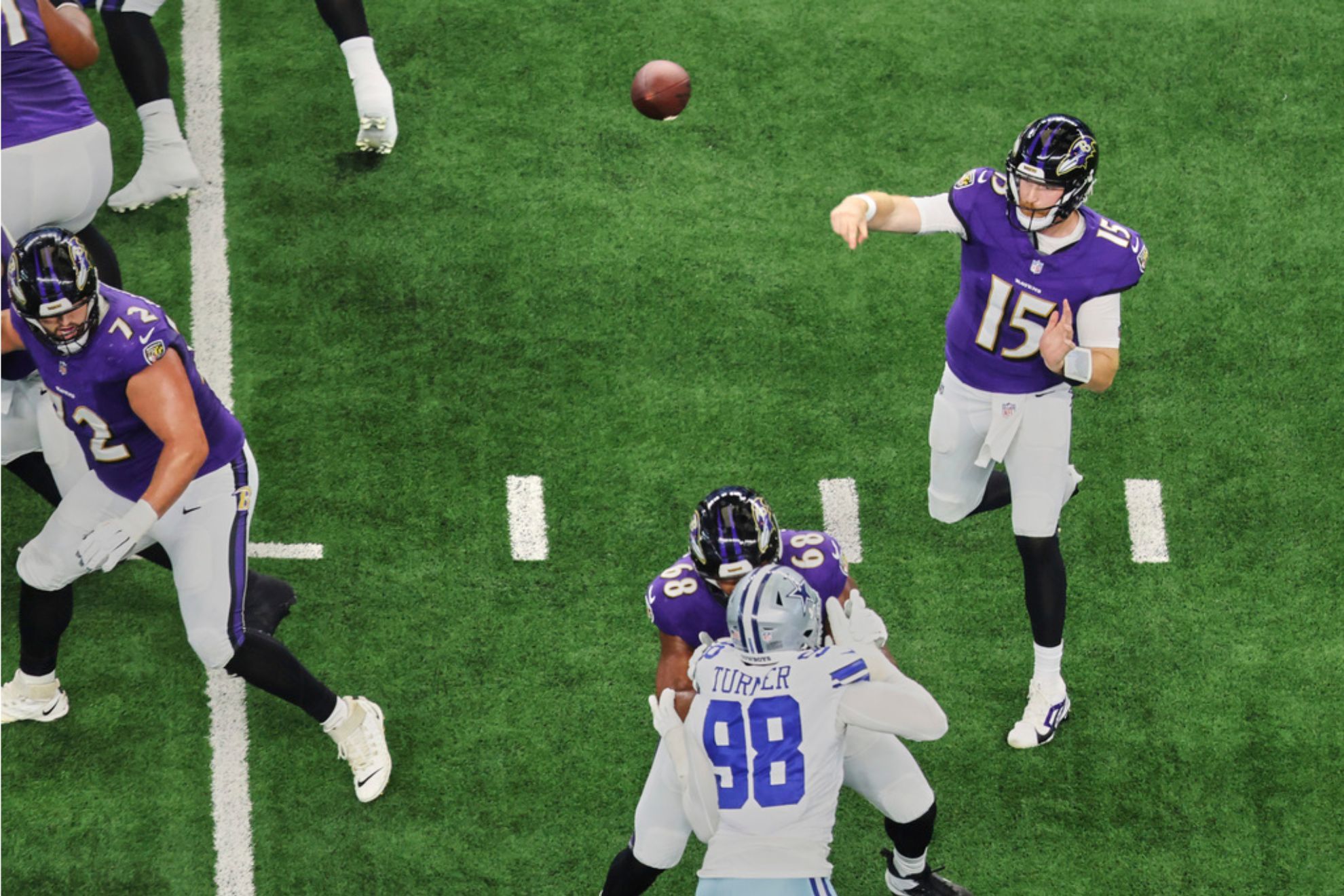 Baltimore Ravens quarterback Cooper Rush throws a pass under pressure from Dallas Cowboys defensive end Payton Turner