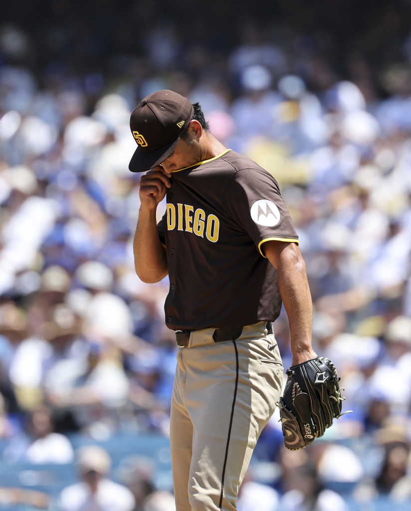 San Diego Padres pitcher Yu Darvish wipes his lip after giving up a three-run home run to Los Angeles Dodgers' Freddie Freeman during the first inning of a baseball game, Sunday, Aug. 17, 2025, in Los Angeles.