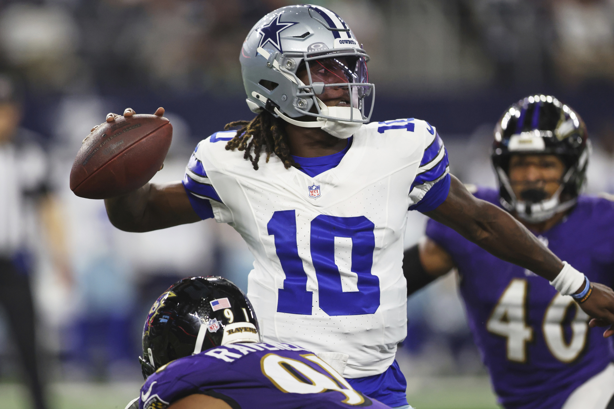 Dallas Cowboys quarterback Joe Milton III (10) throws under pressure from the Baltimore Ravens defense in the first half of a preseason NFL football game Saturday, Aug. 16, 2025, in Arlington, Texas. (AP Photo/Gareth Patterson)
